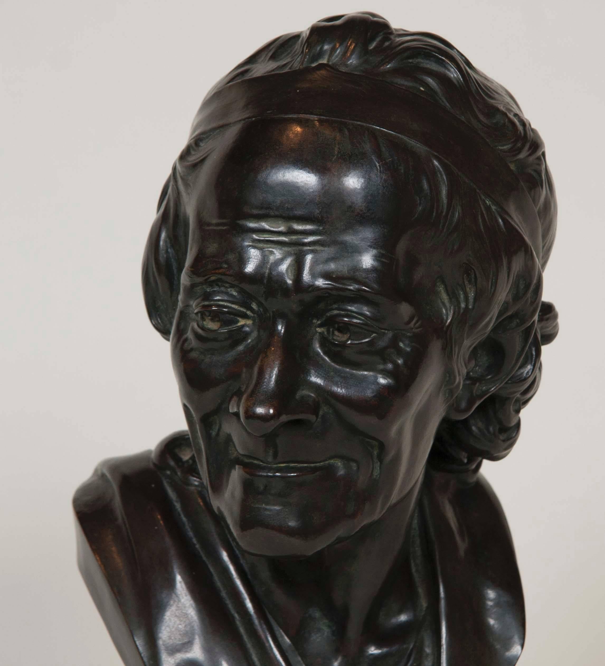 A 20th century bronze bust of Voltaire after French sculptor Jean Antoine Houdon. Unmarked.