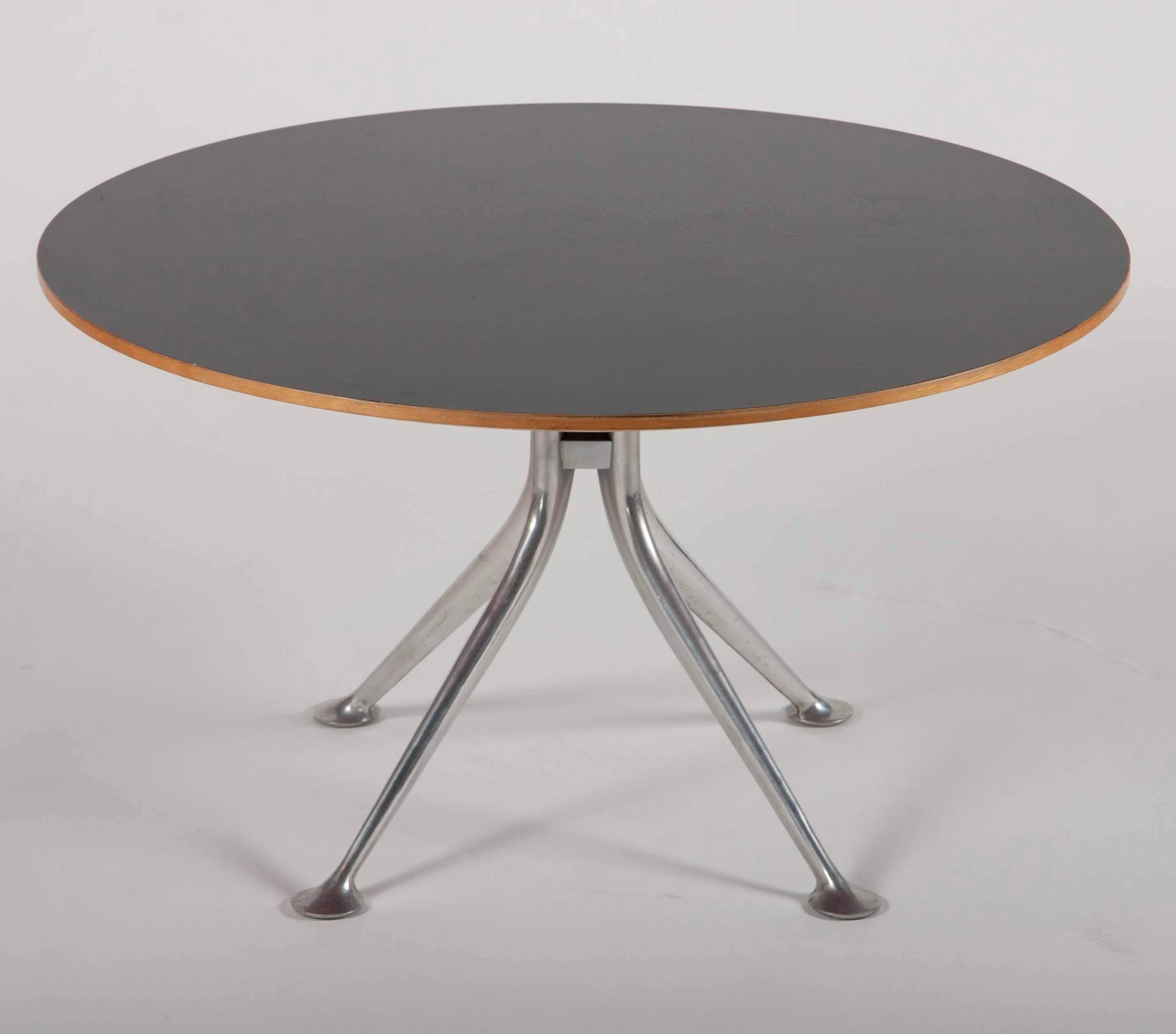 This rare form of Alexander Girard's round coffee table was only briefly made in the 1960s by Herman Miller.
  
