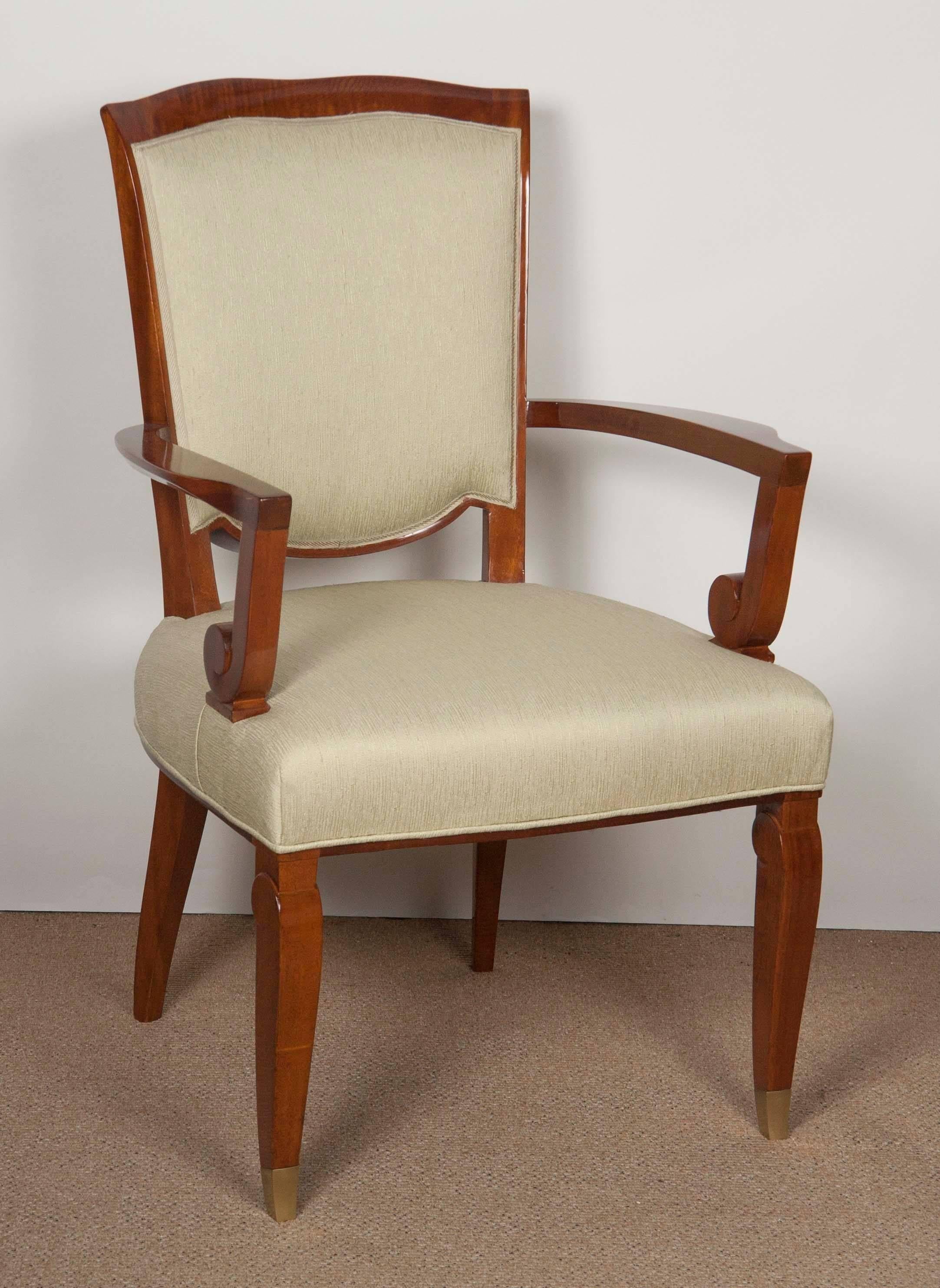 A Jules Leleu open armchair created using very impressively figured mahogany with front legs terminating in silvered sabot. Stamped with number on leg. Currently finished in Muslin.