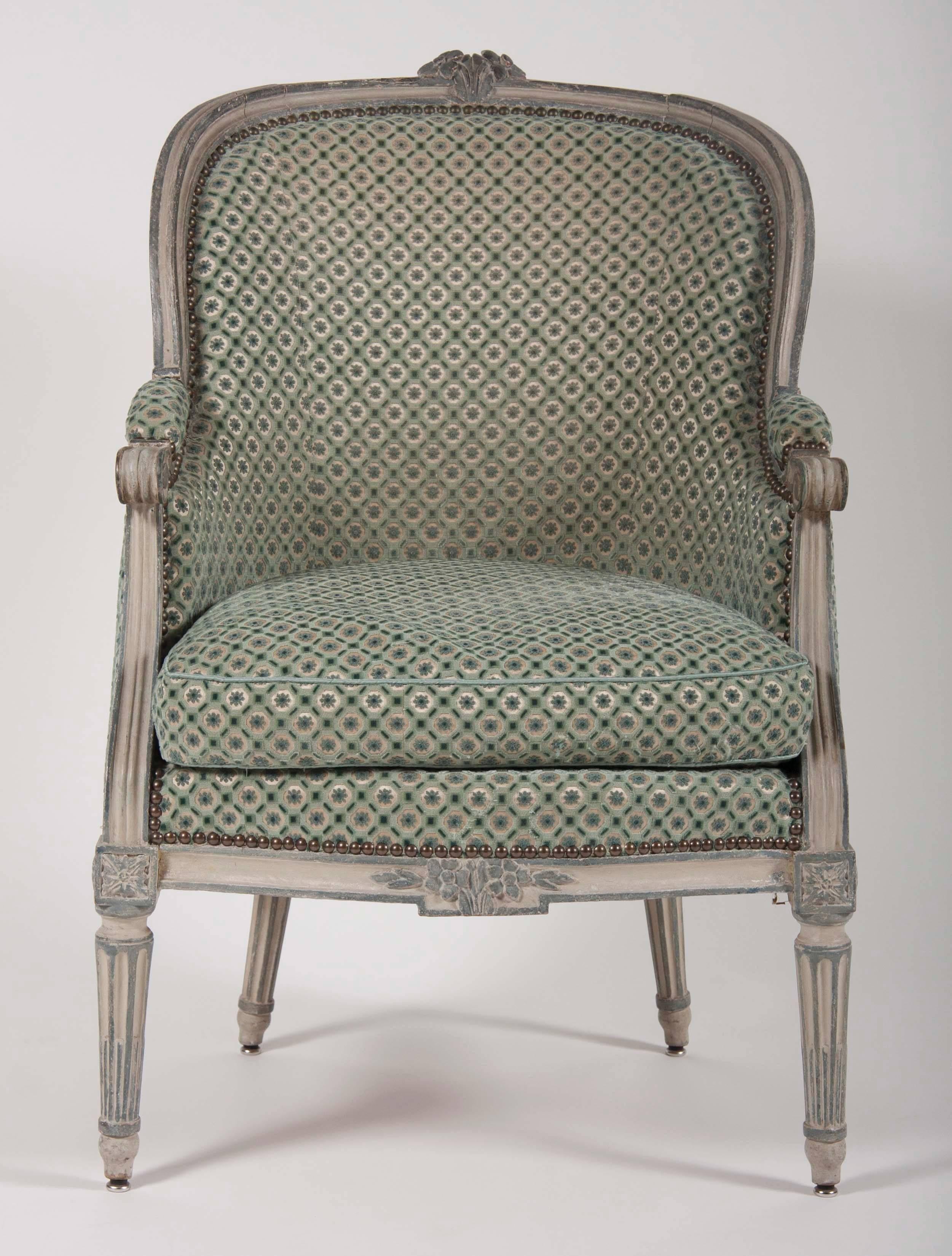 A beautiful pair of Louis XVI blue and grey painted upholstered bergeres.