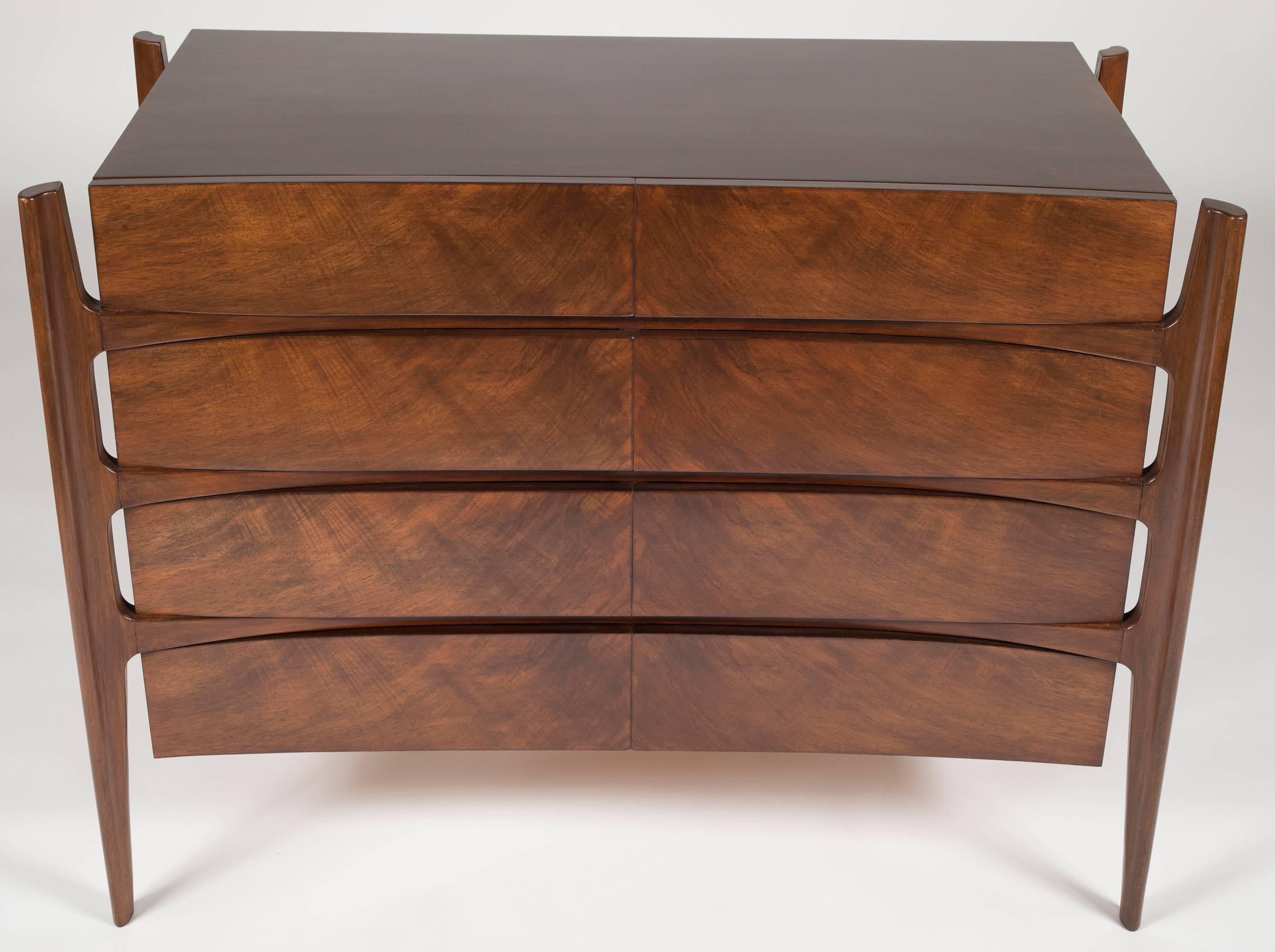 A walnut chest with eight drawers and finished back. The chest was designed by William Hinn for Urban Furniture