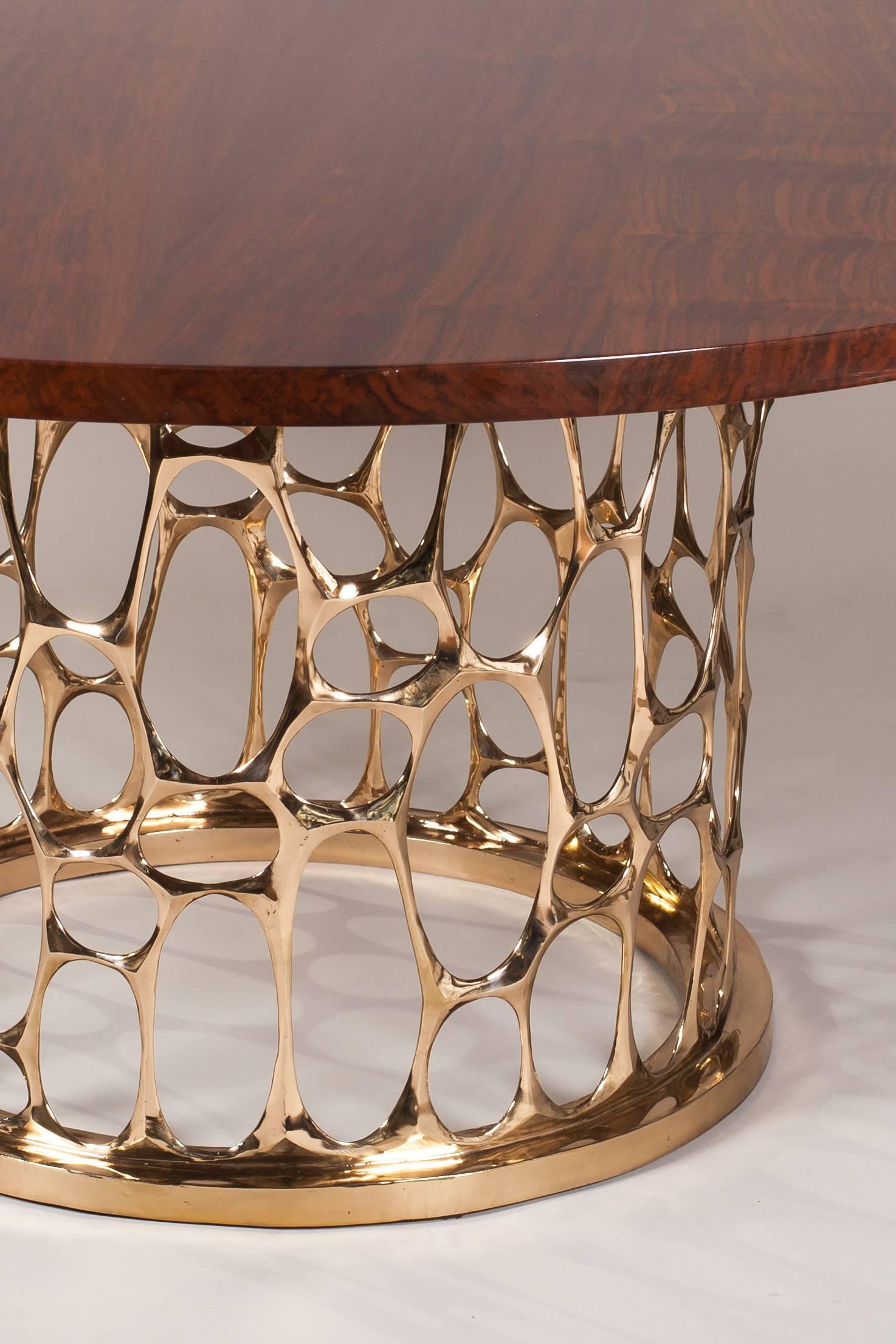Sculpted bronze base with beautiful Claro Walnut top. One of a kind, single production piece.

The Homage to Gaudi table is crafted using the lost-wax casting method; a painstaking process that allows the artist to prior create and sculpt his