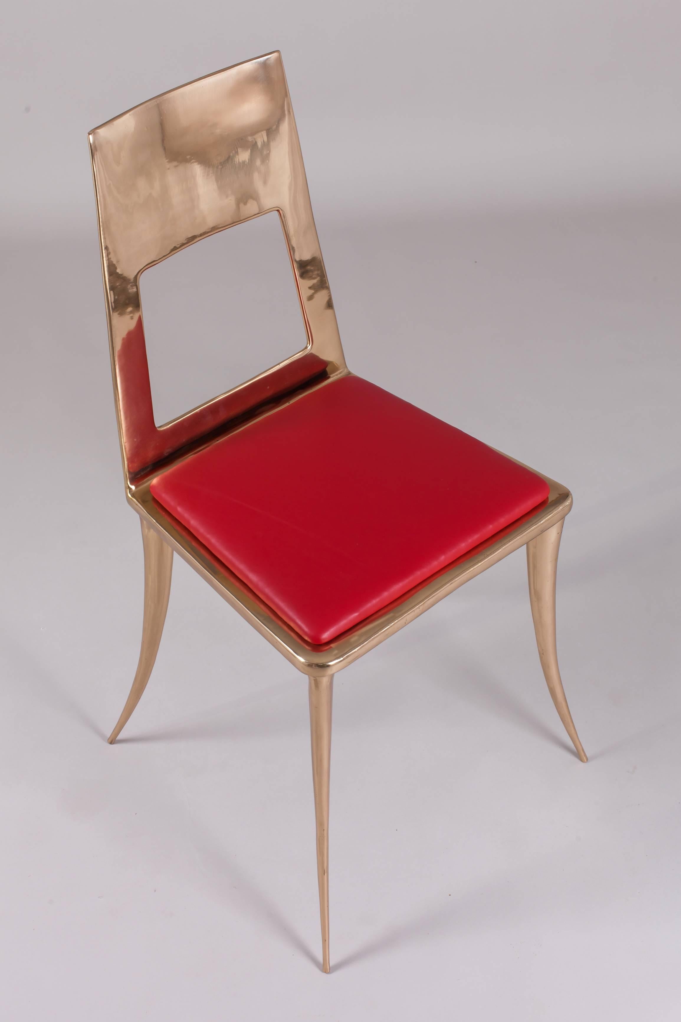 The Modern Klismos chair is hand-sculpted and cast in bronze using the time-honored method of lost-wax casting. After casting, the chair is painstaking sanded by hand to create a polished bronze finish. Nick Alan King is one of few living American