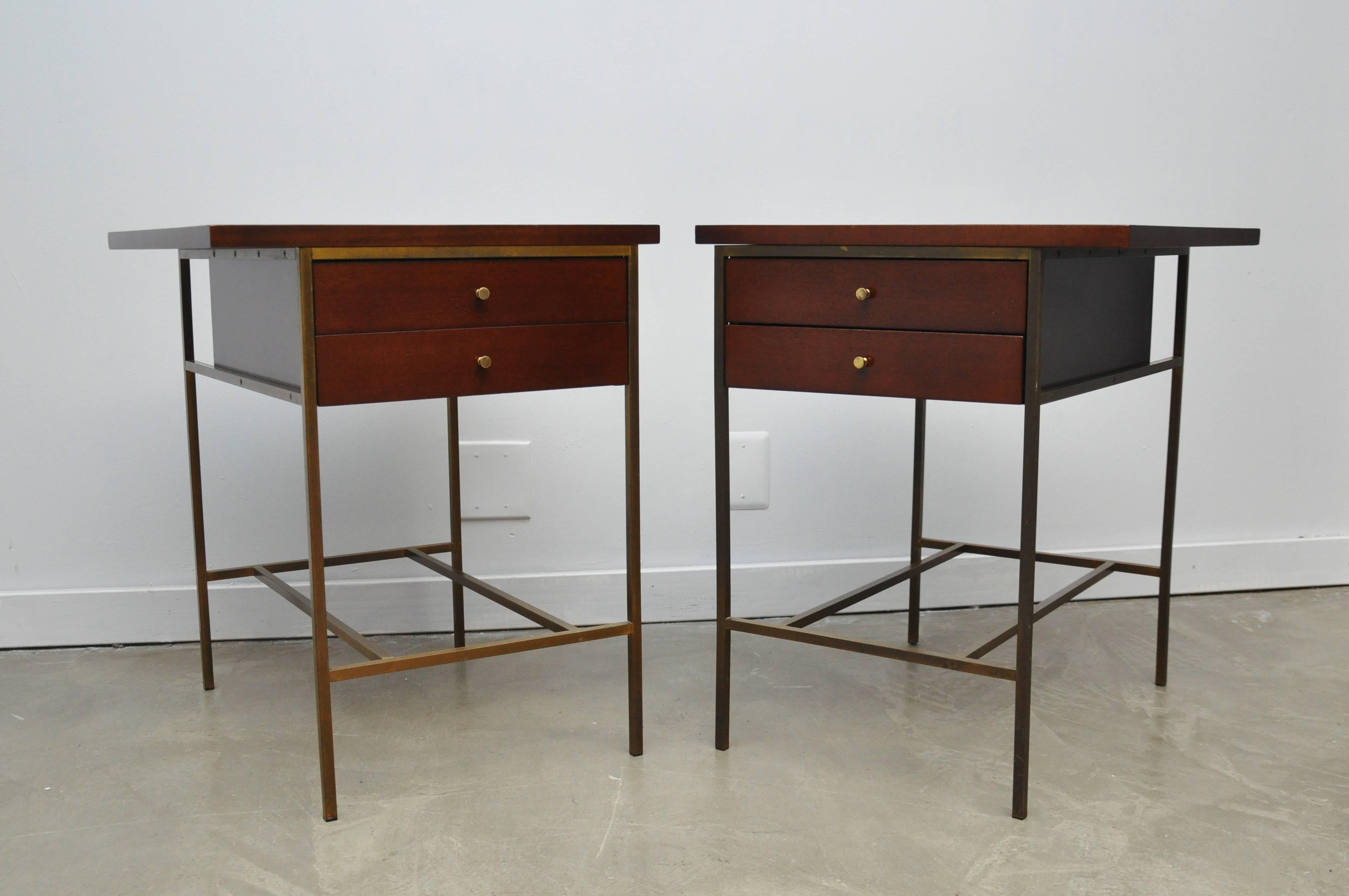 Pair of brass frame nightstands or end tables by Paul McCobb for Calvin furniture. Cases and tops have been fully restored/refinished. Nice original golden patina to brass.