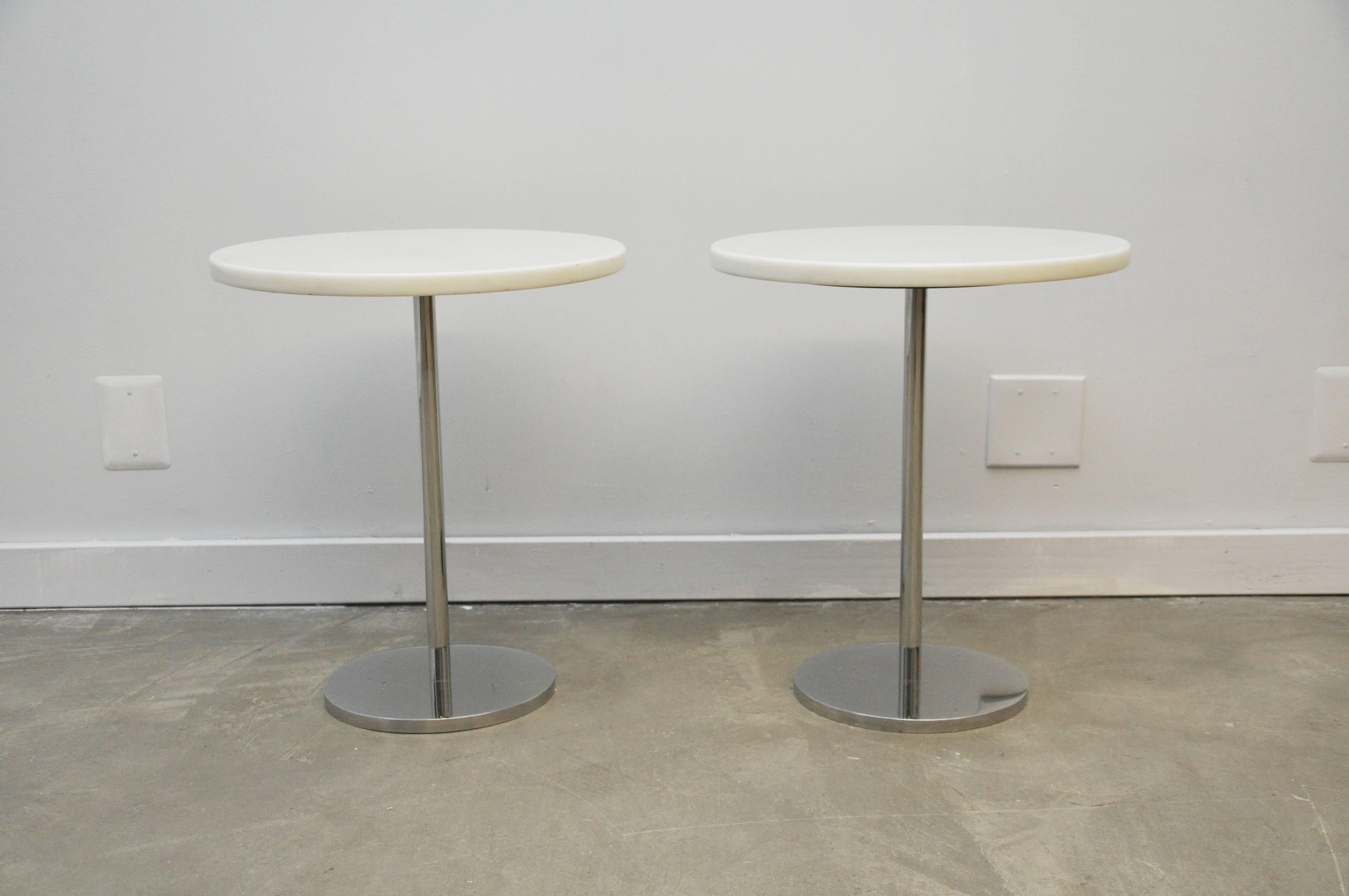 Pair of white marble side tables with polished stainless steel bases. Custom produced by Gerald R. Griffith Studio, circa 1970. Very heavy, top quality Minimalist design.