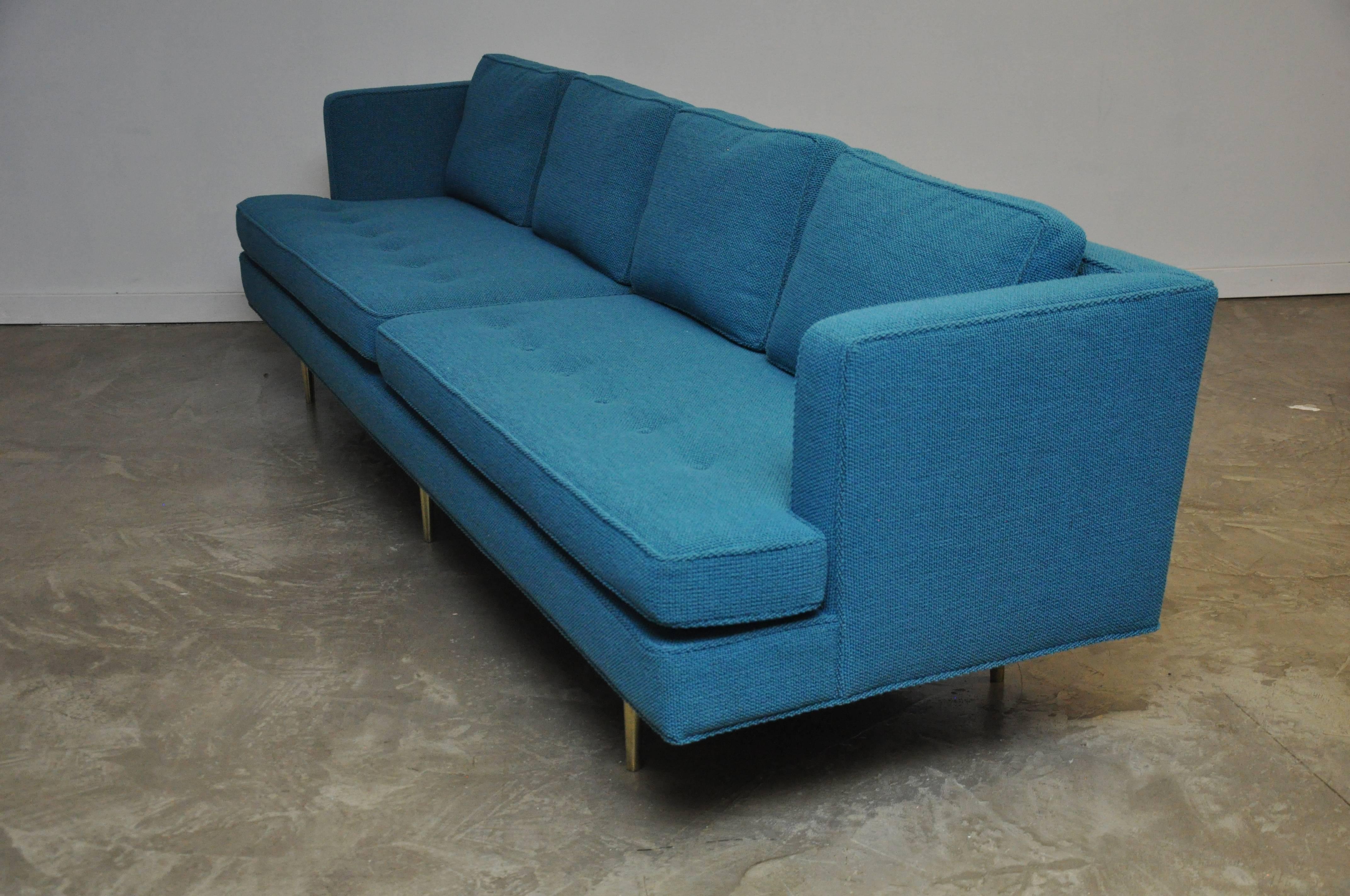 Monumental sofa designed by Edward Wormley for Dunbar. Fully restored. Polished and lacquered brass legs with new Knoll Aegean/Turquoise bouclé fabric. New foam seat cushions with down filled back cushions.