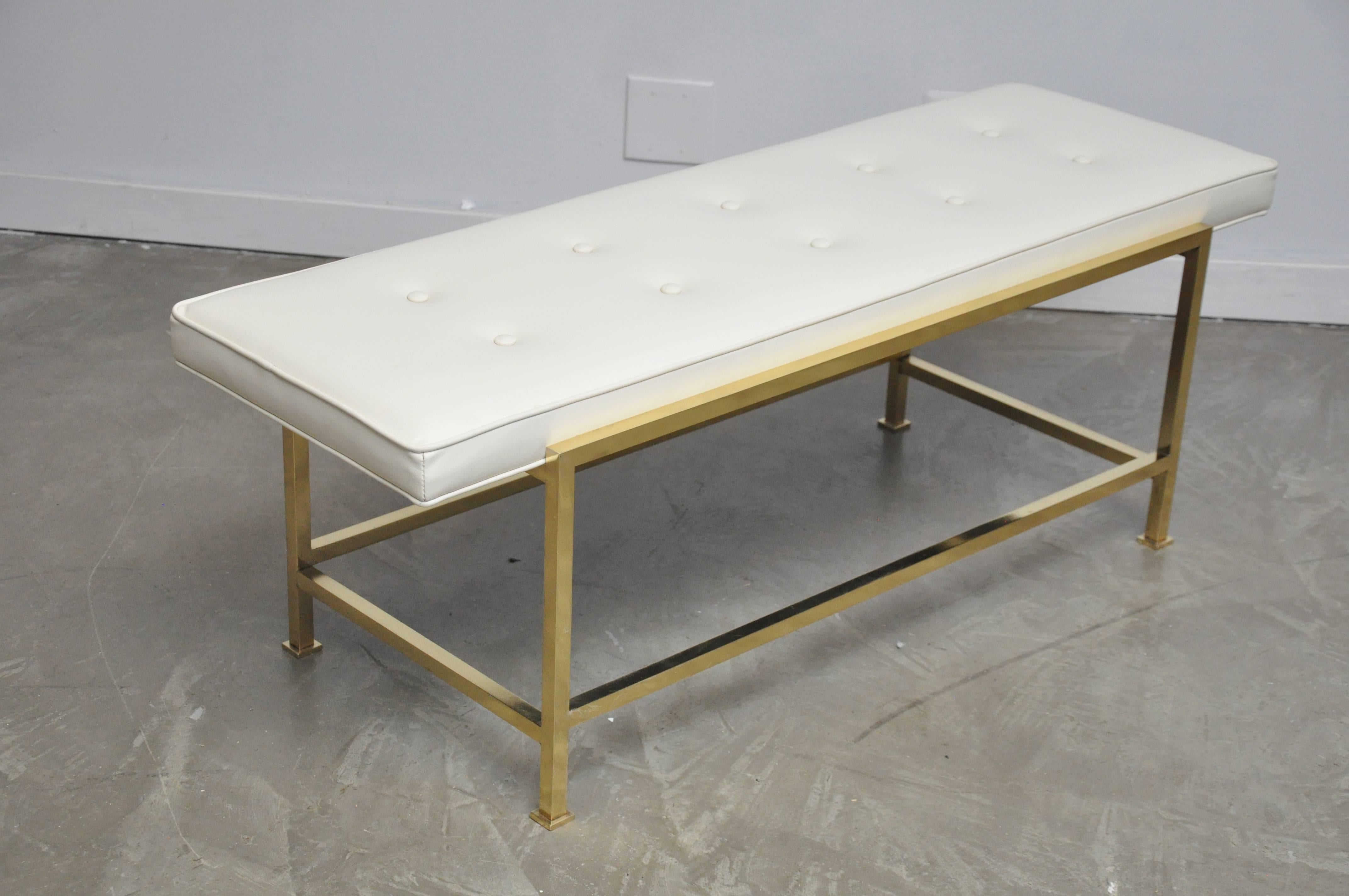 Brass base bench by Edward Wormley for Dunbar. Newly upholstered in white leather. Design circa 1950.