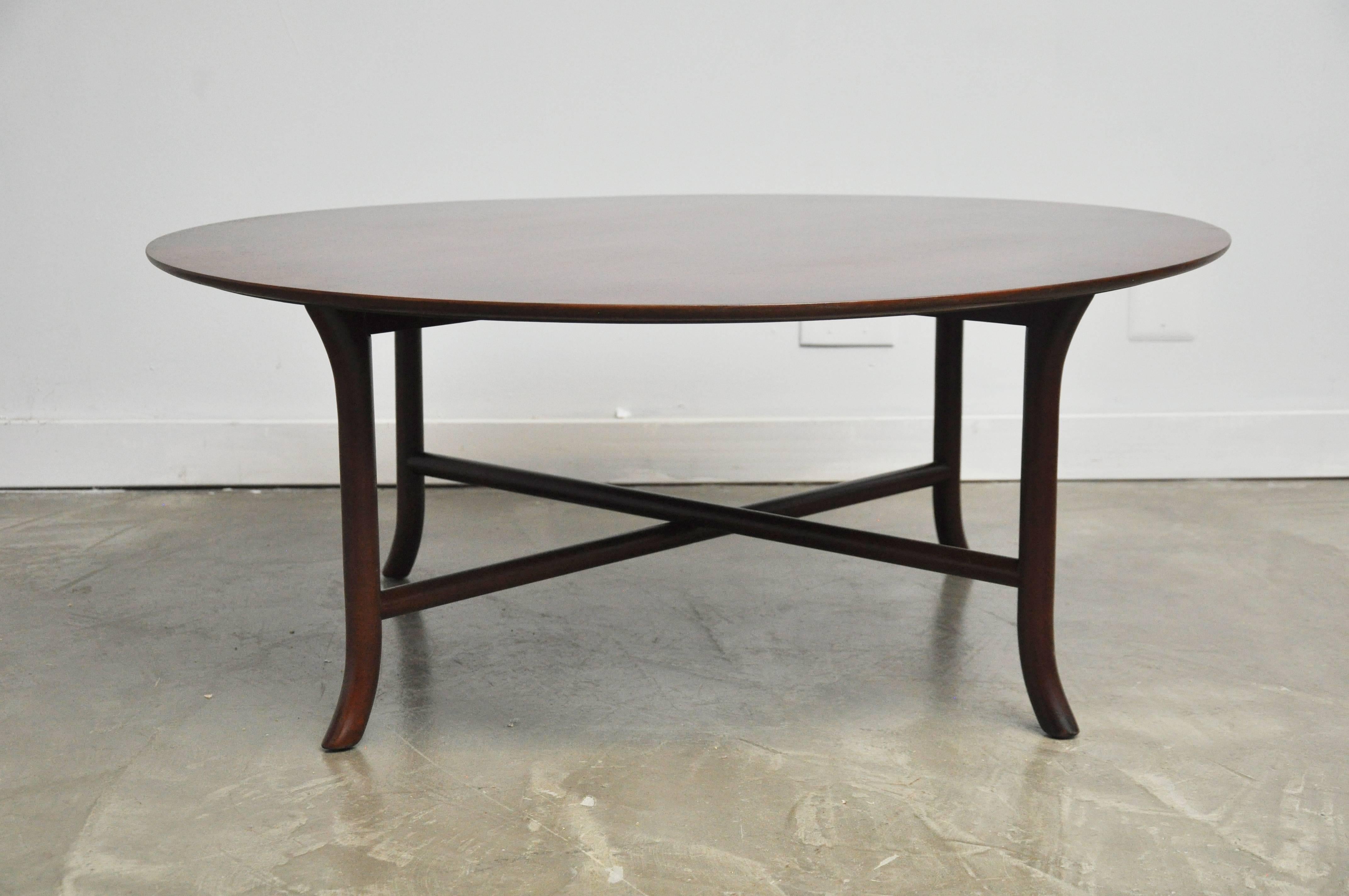 Circular saber leg coffee table by TH Robsjohn-Gibbings. Fully restored, refinished in dark walnut tone.