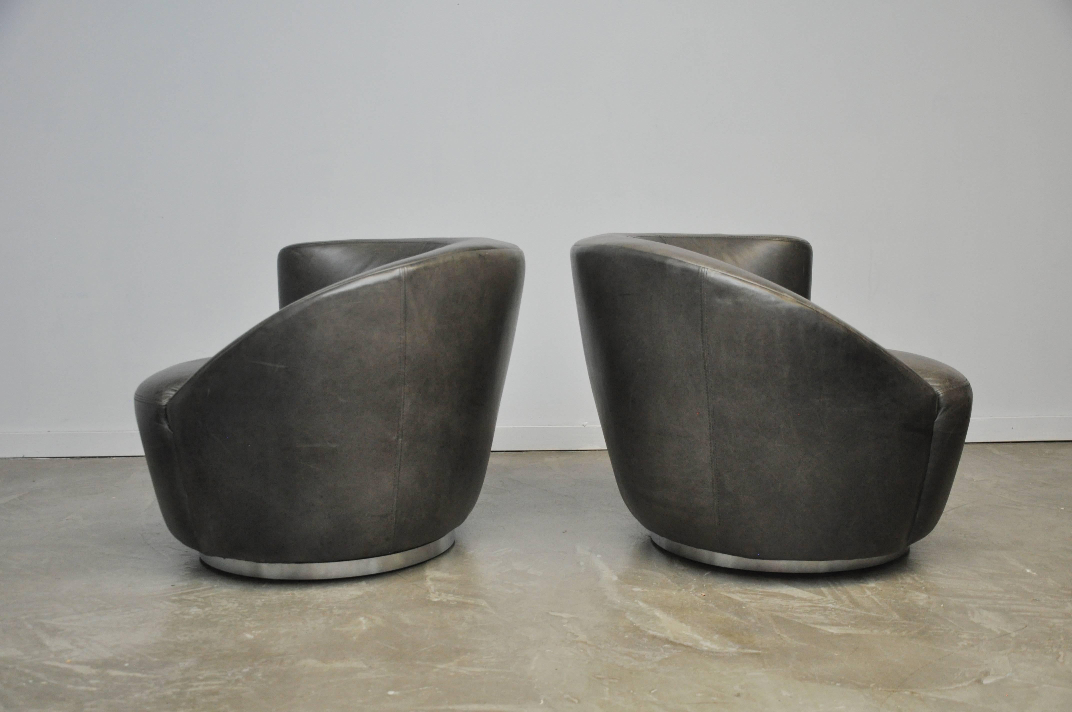 Pair of Vladimir Kagan Naultilus swivel chairs. Original grey leather with beautiful patina on chrome bases.