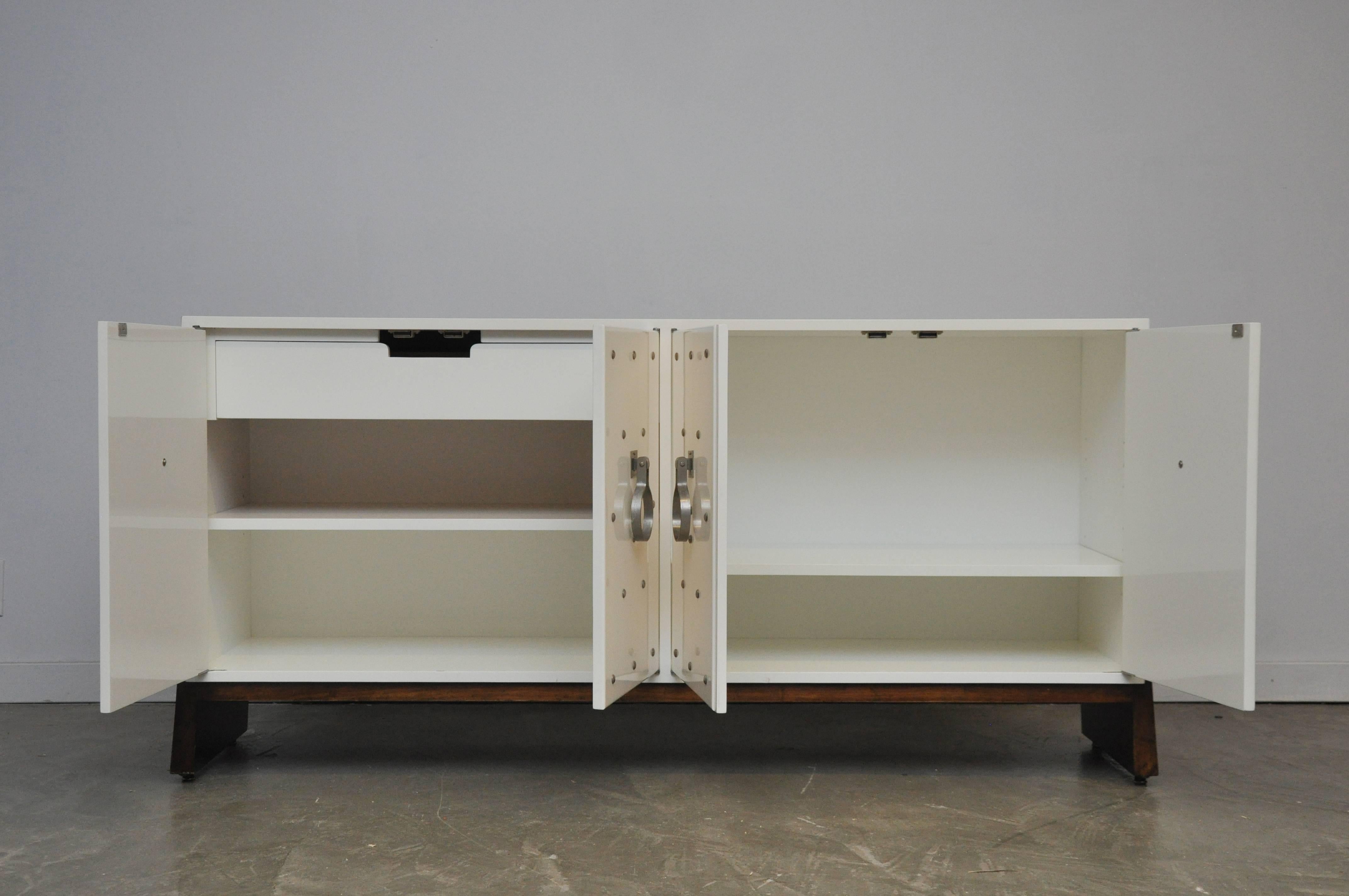Beautiful white lacquer sideboard with nickel studs and pulls by Tommi Parzinger.  Beautiful and recently restored.