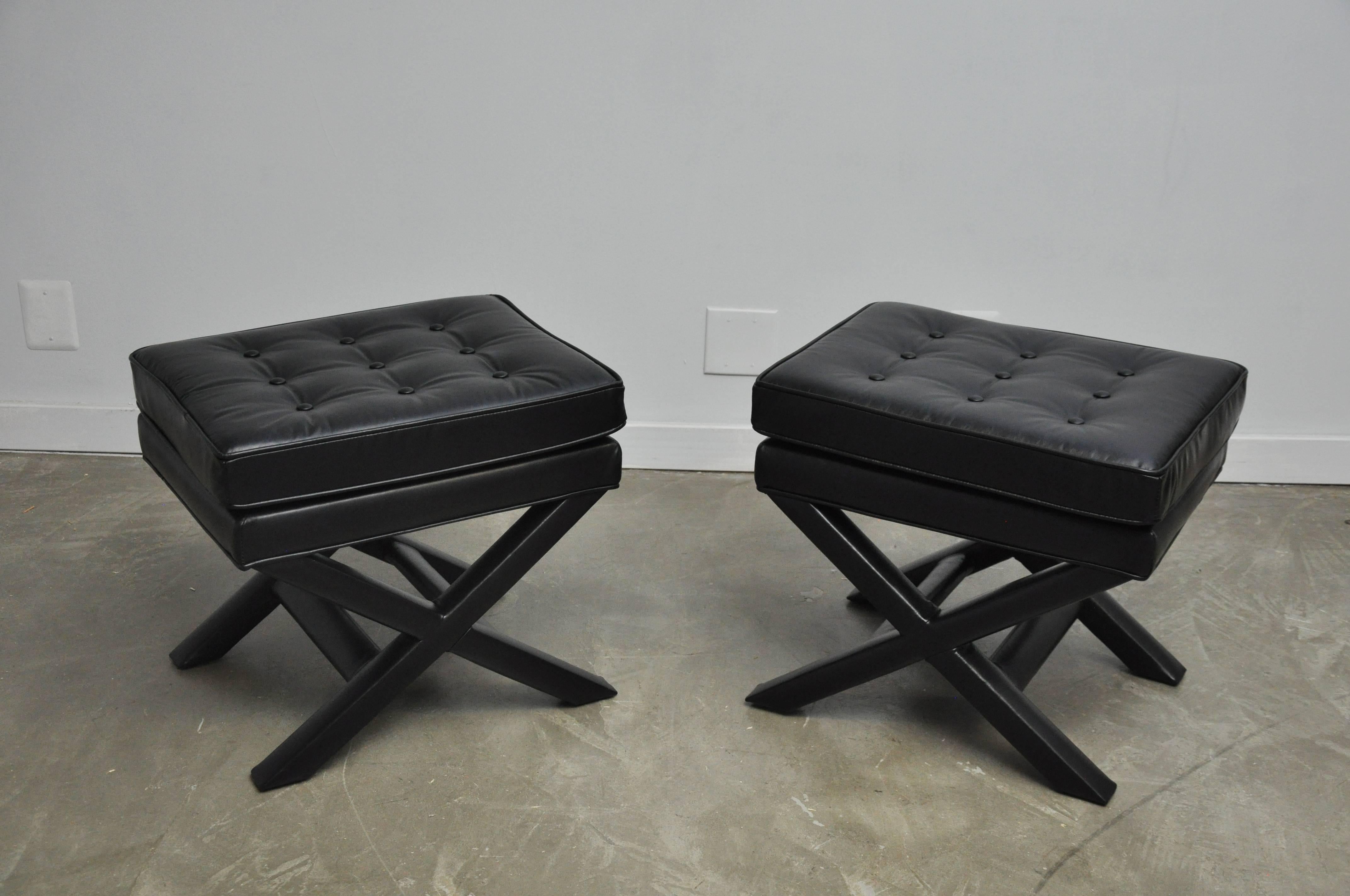 Pair of vintage X-base benches with new black leather upholstery.