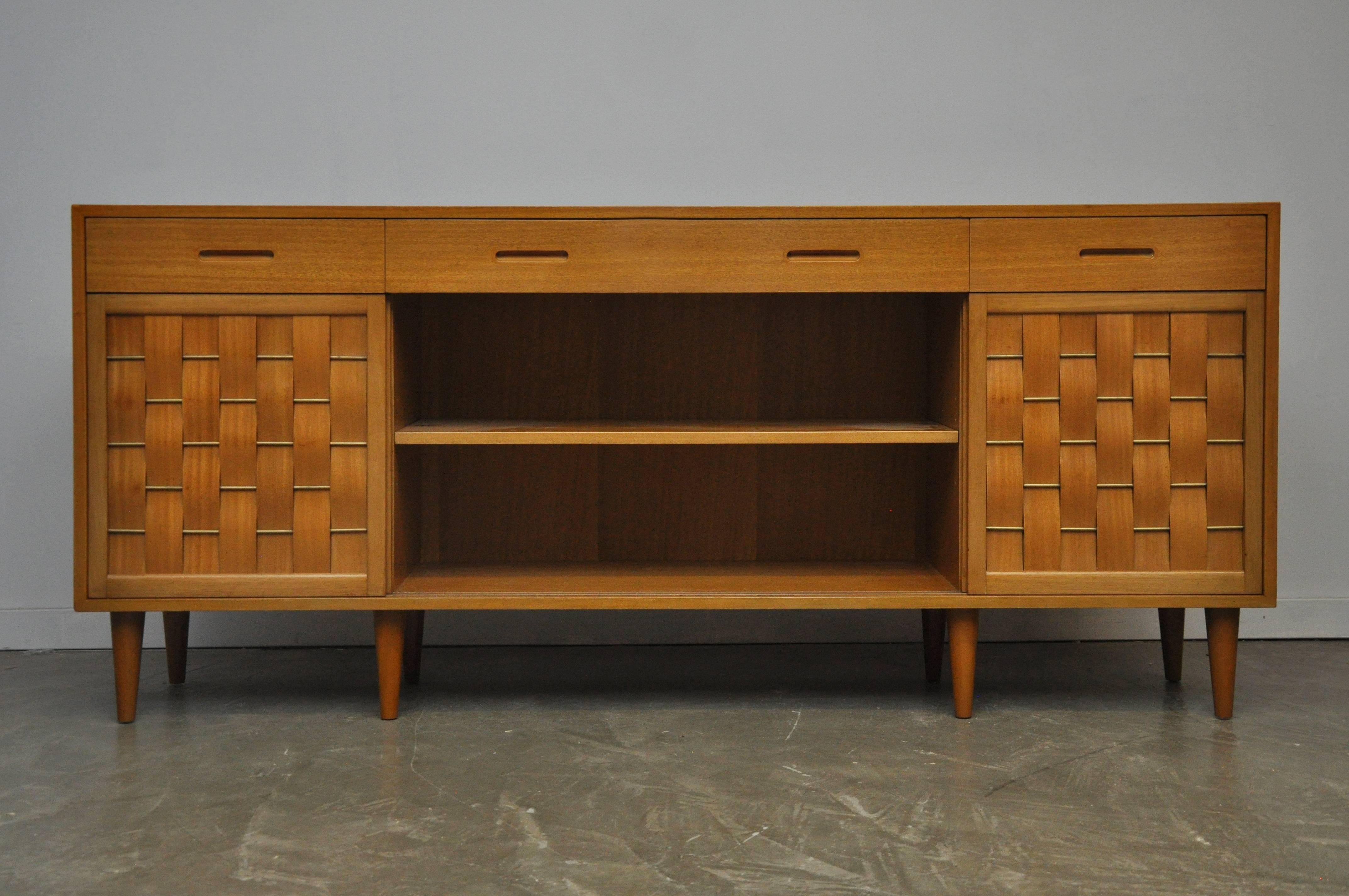 Large four-door sideboard designed by Edward Wormley for Dunbar. Model #5668. Mahogany case with brass details on doors. Four sliding doors.