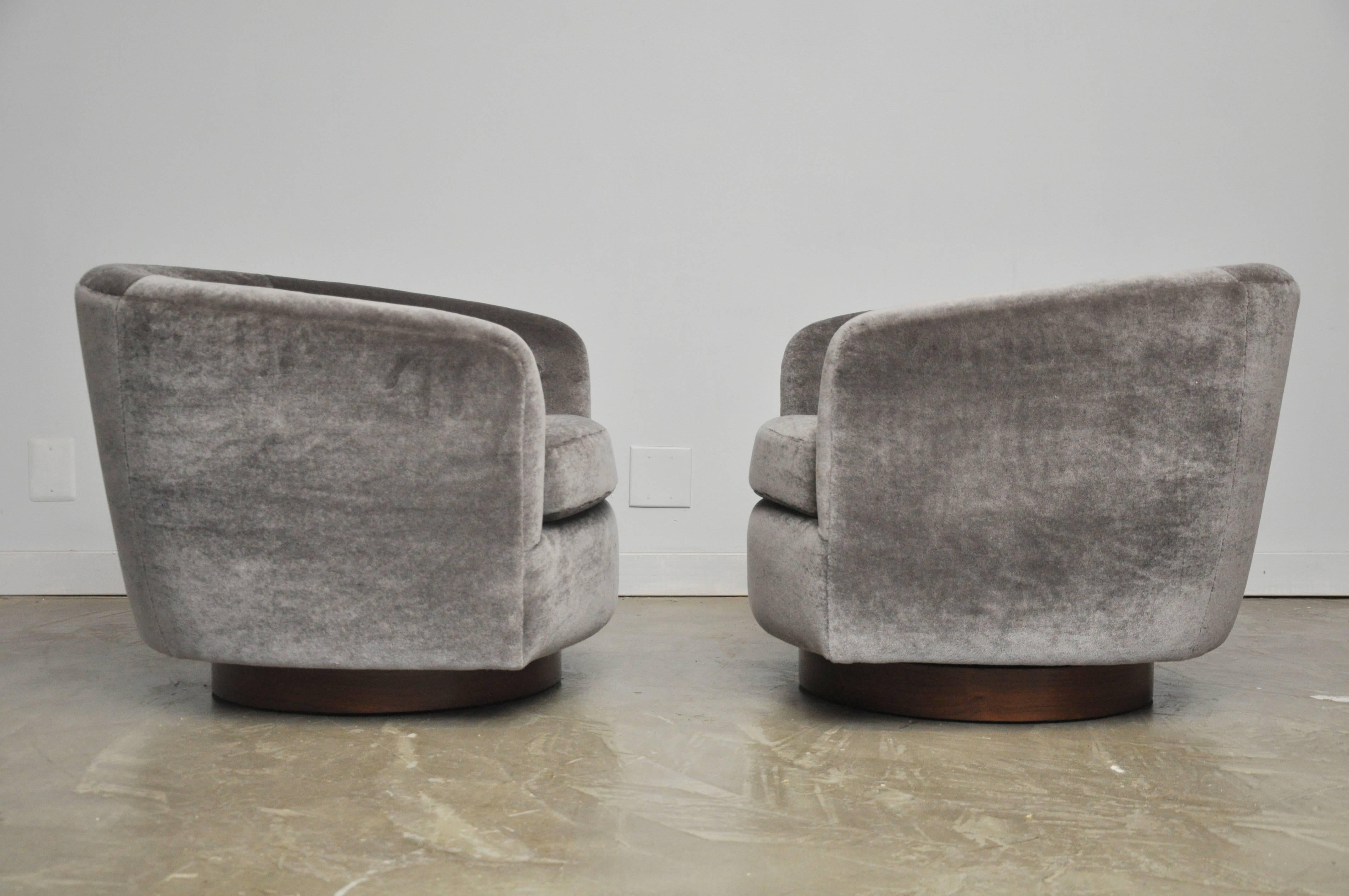 Pair of swivel and rock chairs by Milo Baughman. Fully restored and refinished bases. New ultra plush mohair upholstery.