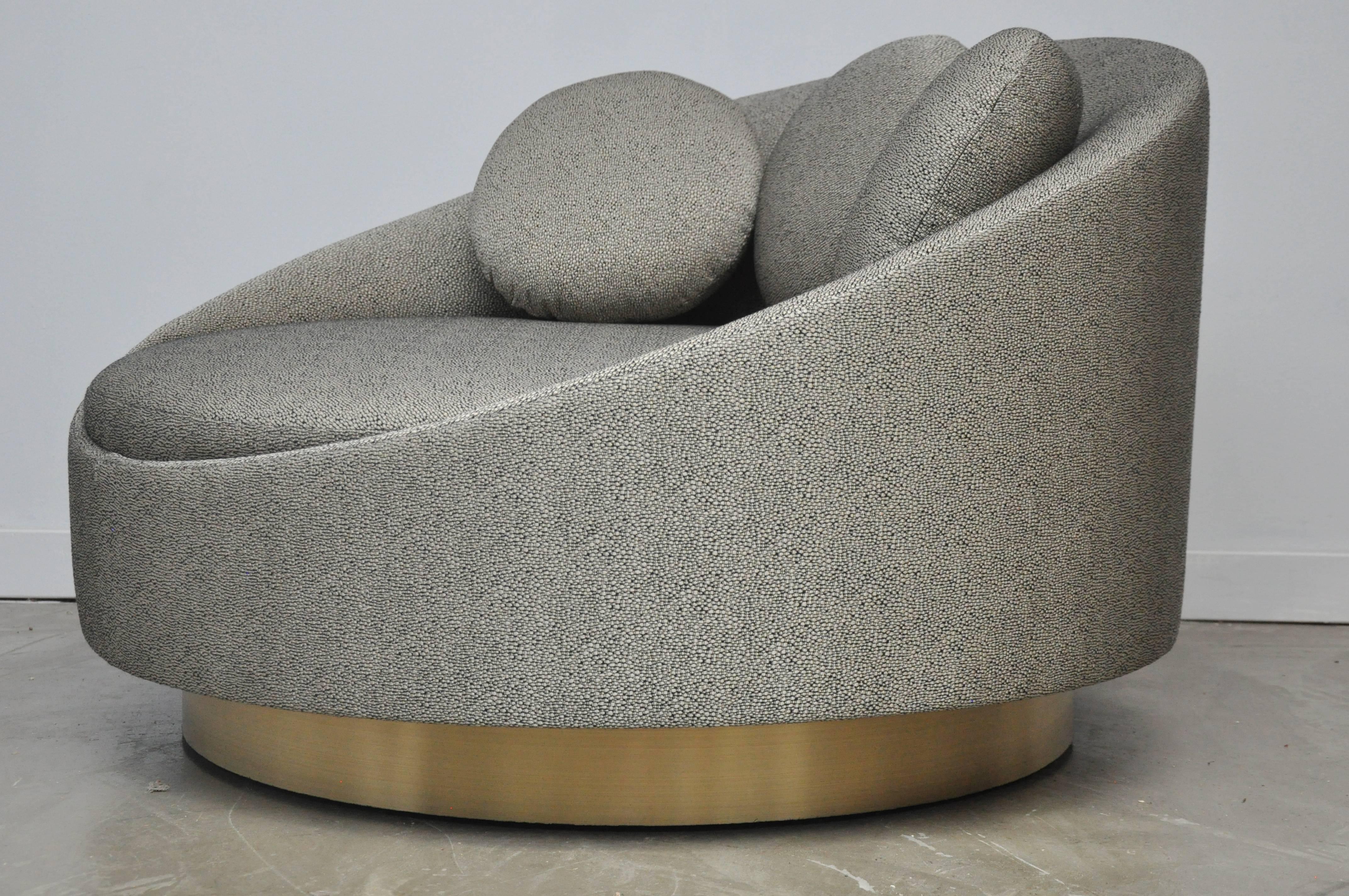Oversized cuddle swivel chair by Adrian Pearsall. Fully restored. Brushed brass base with new black and gold upholstery.