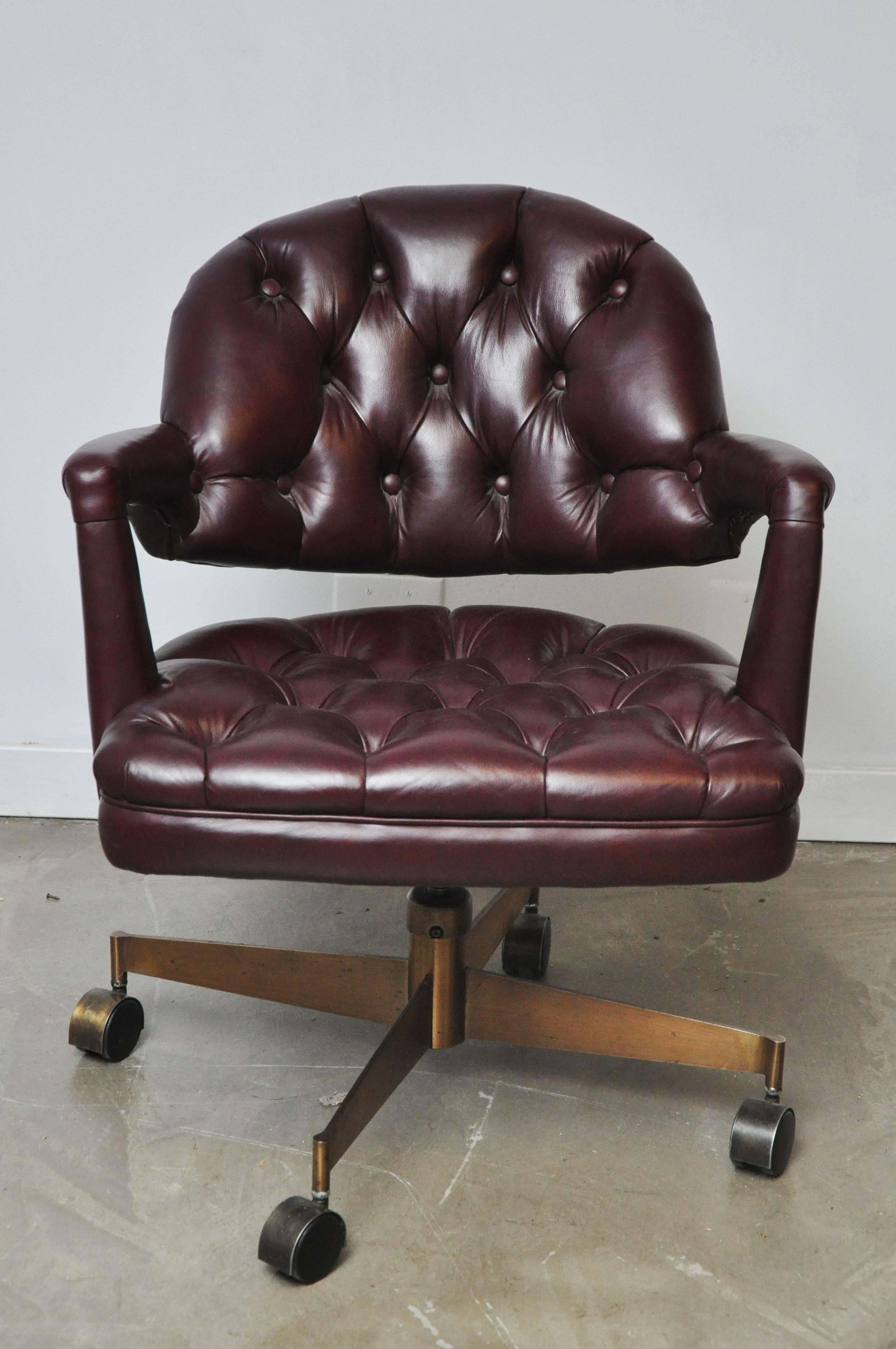 Leather tufted desk chair by Edward Wormley for Dunbar. Beautiful burgundy leather with bronze base, circa 1954. Adjustable seat height.