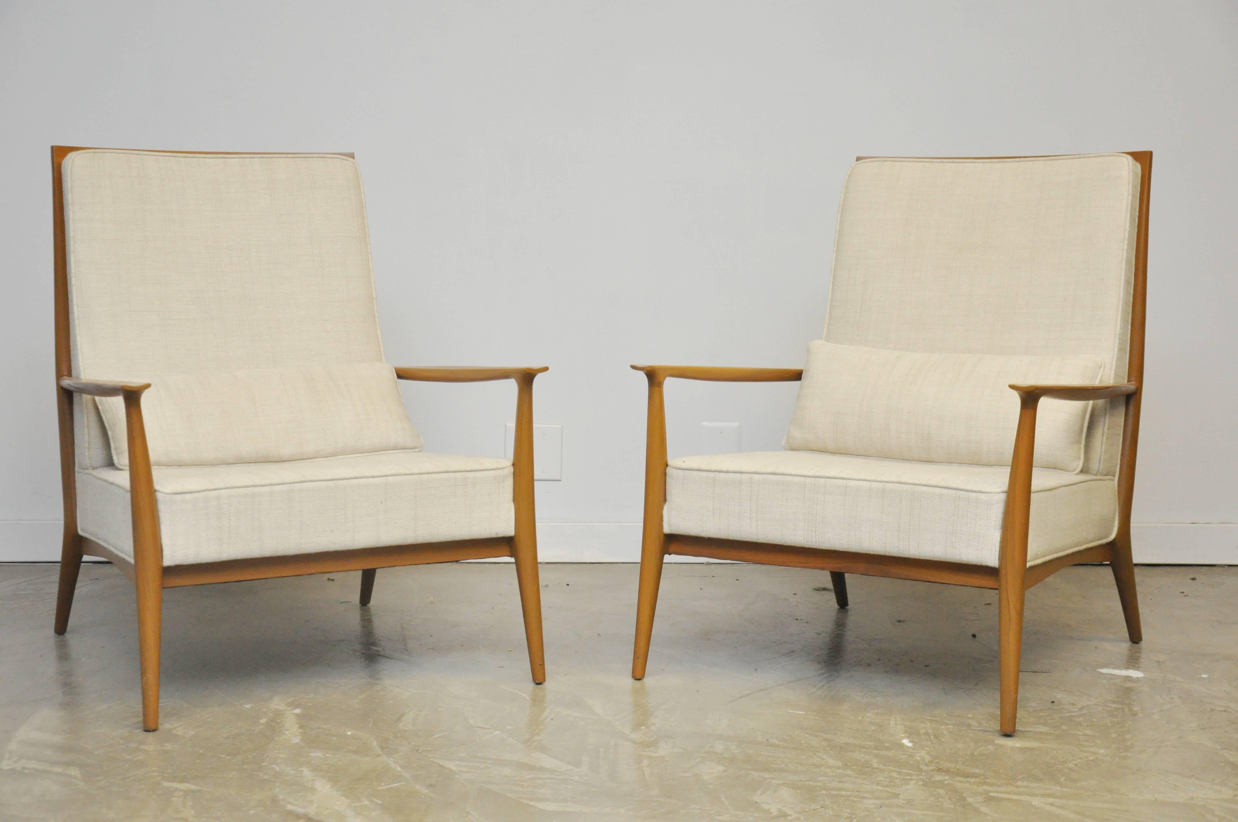 Pair of lounge chairs designed by Paul McCobb for Directional. Newer oatmeal weave upholstery over walnut frames.