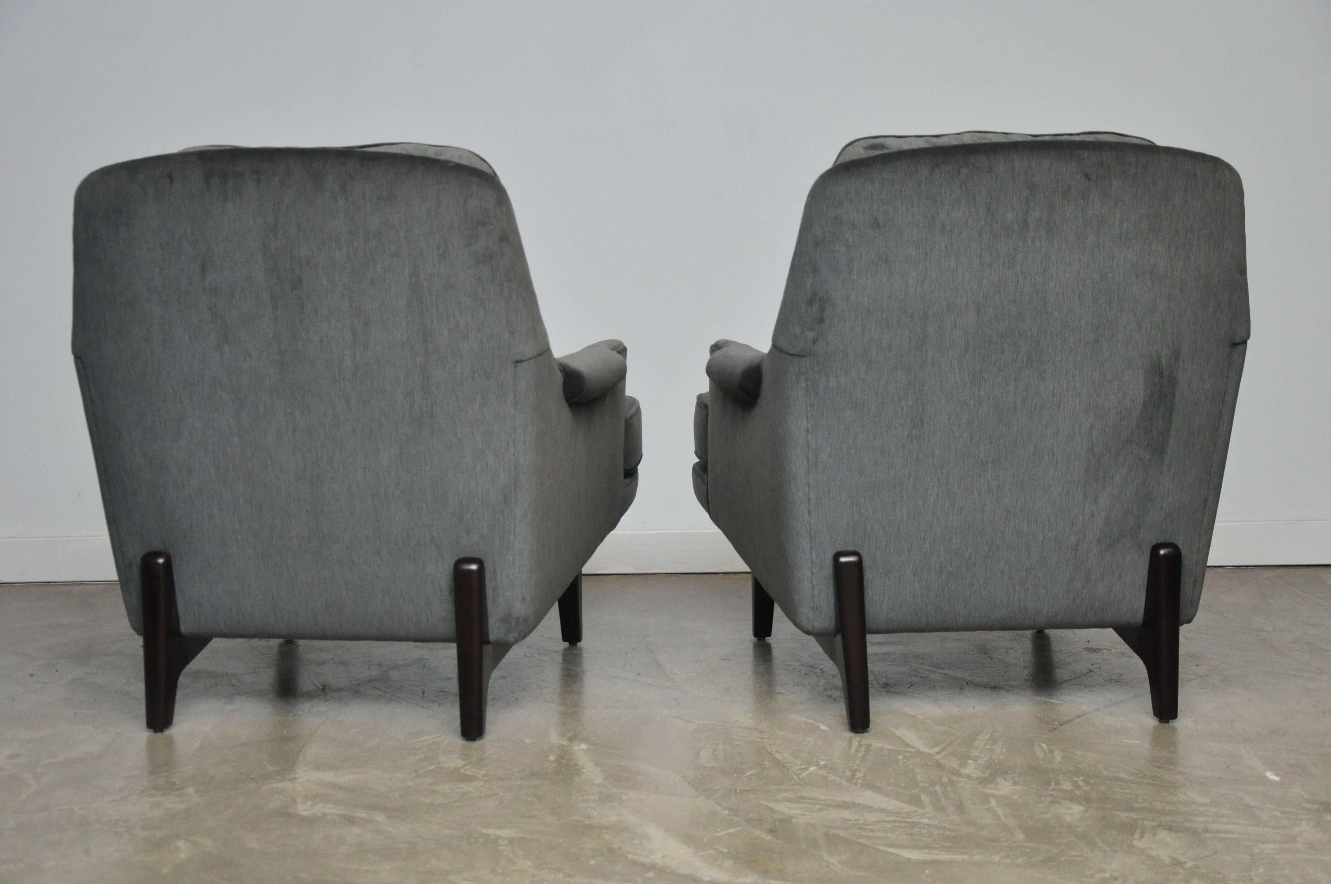 Pair of Dunbar lounge chairs designed by Roger Sprunger for Dunbar. Fully restored. Refinished mahogany bases in Classic espresso tone. New cushions, foam and soft grey velvet. Beautiful form.