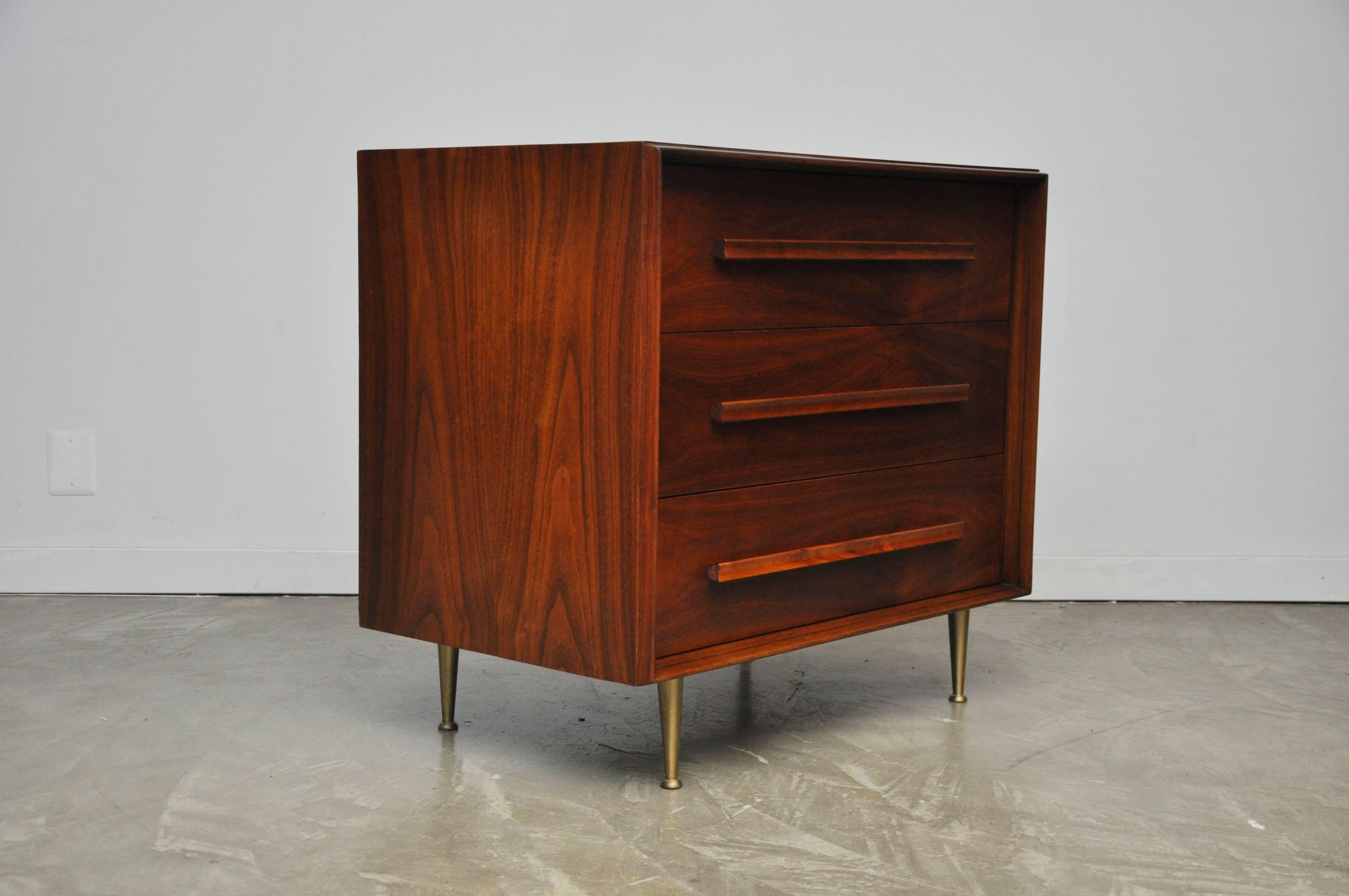 Walnut three-door chest by T.H. Robsjohn-Gibbings for Widdicomb. Fully restored and refinished.

Matching pair of nightstands available.