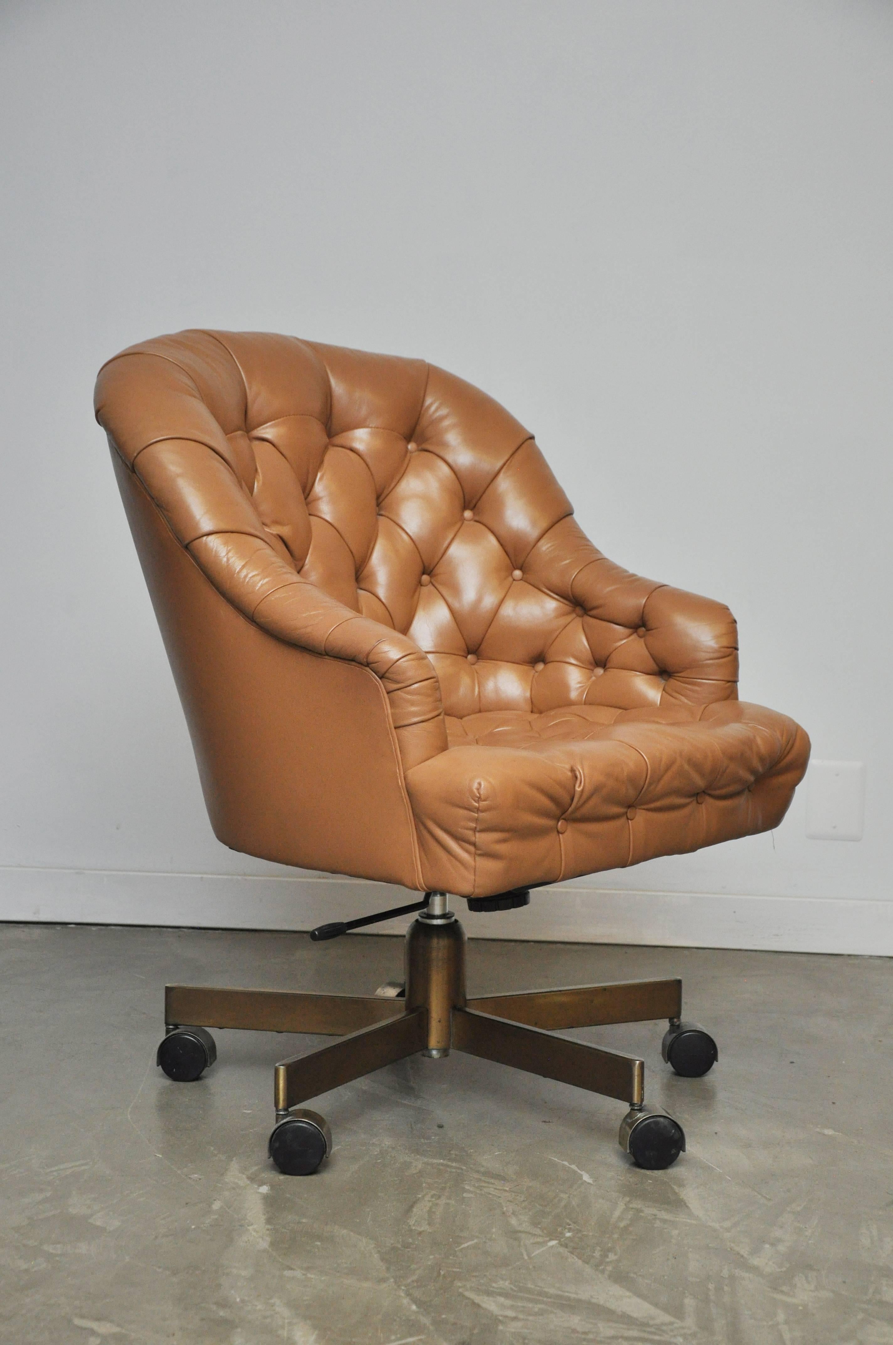 Classic leather Chesterfield tufted executive office chair by Edward Wormey for Dunbar. Original tan leather in excellent condition with bronze base. Adjustable height and tilt.