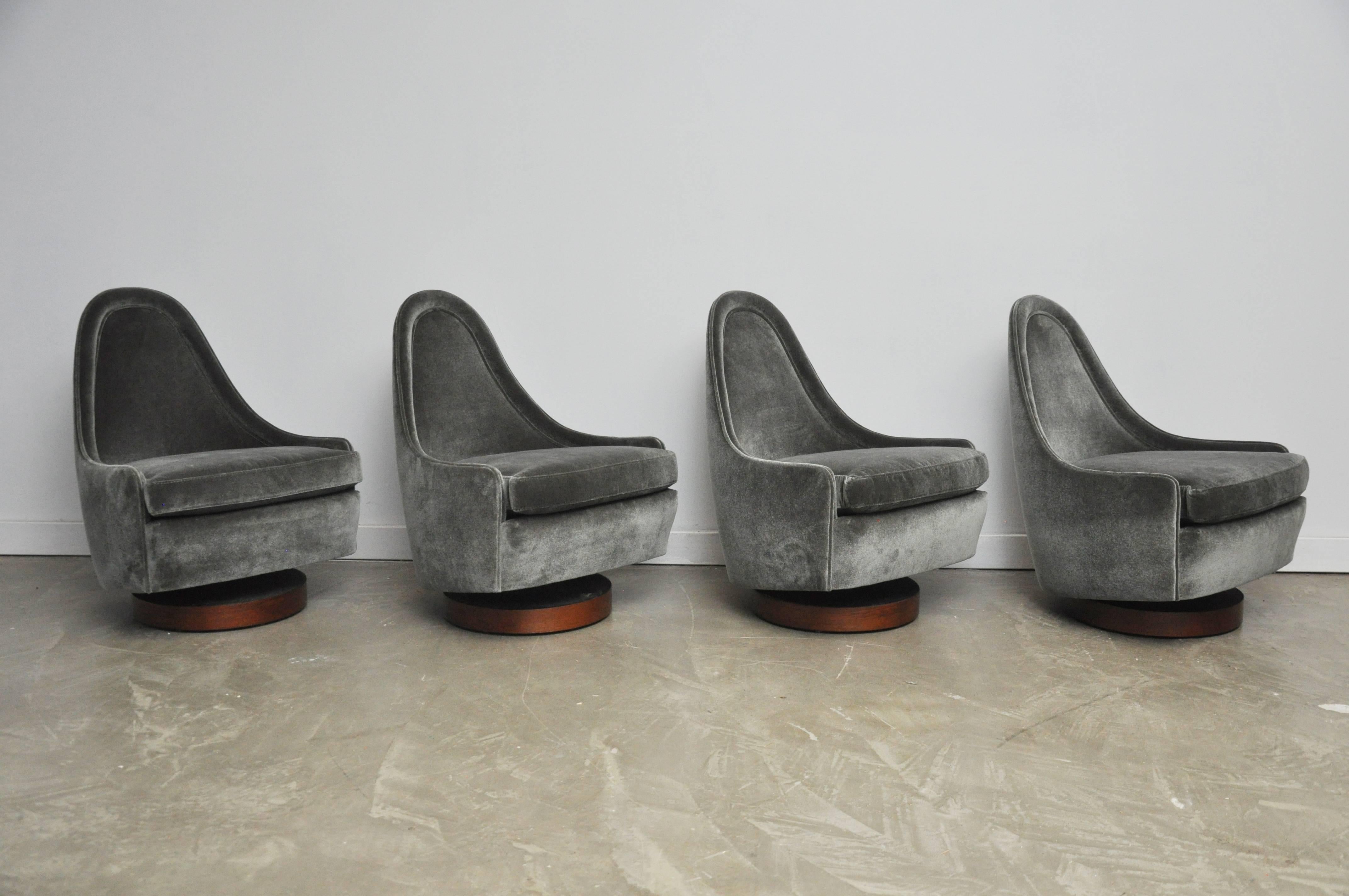 Teardrop shape lounge chairs on walnut swivel bases by Milo Baughman. Unique petite form perfectly fits body form. Chairs swivel and tilt. Fully restored and reupholstered.

Will sell in pairs.