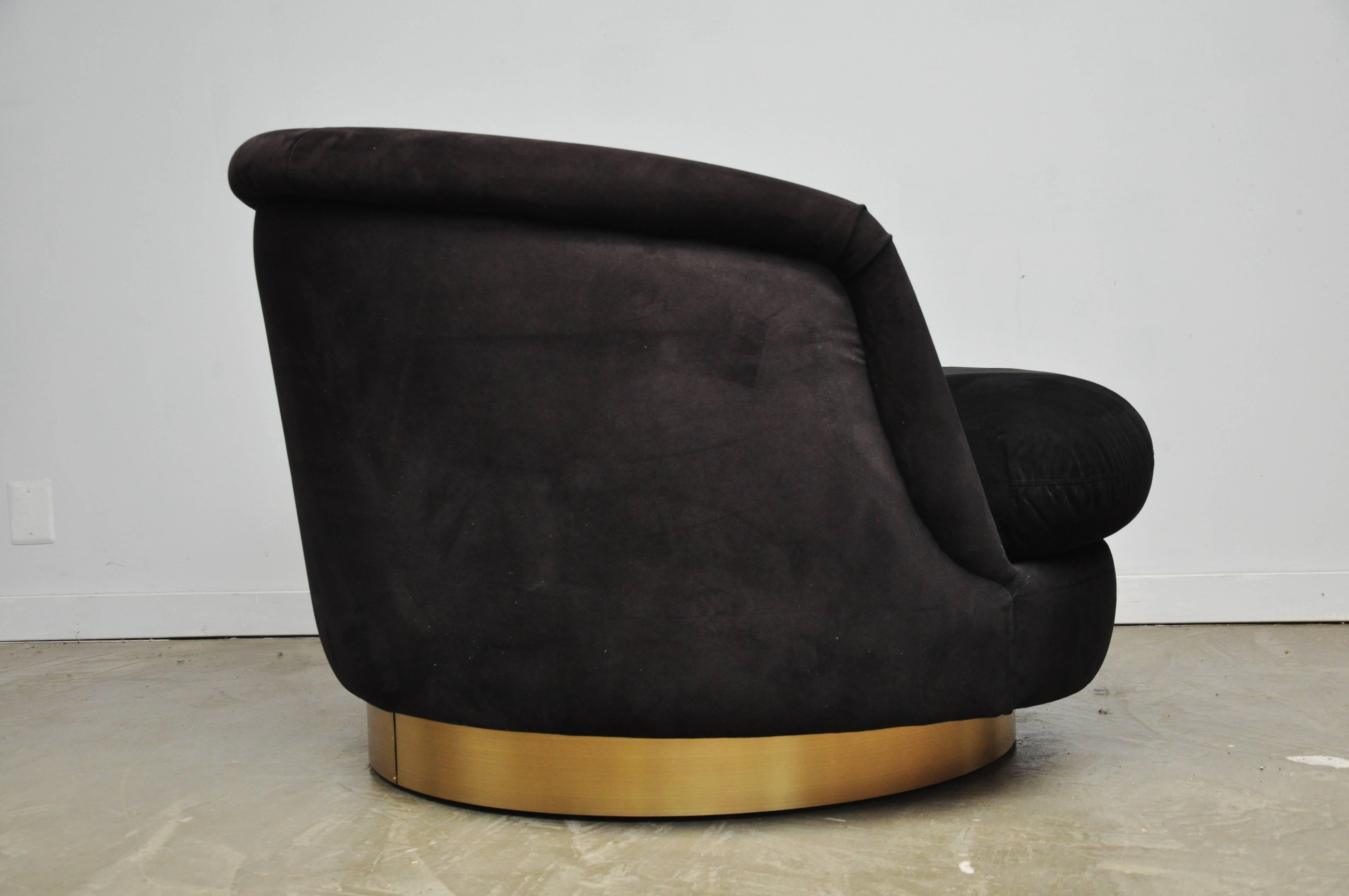 Large Milo Baughman swivel chair. Original black fabric on brass base.
