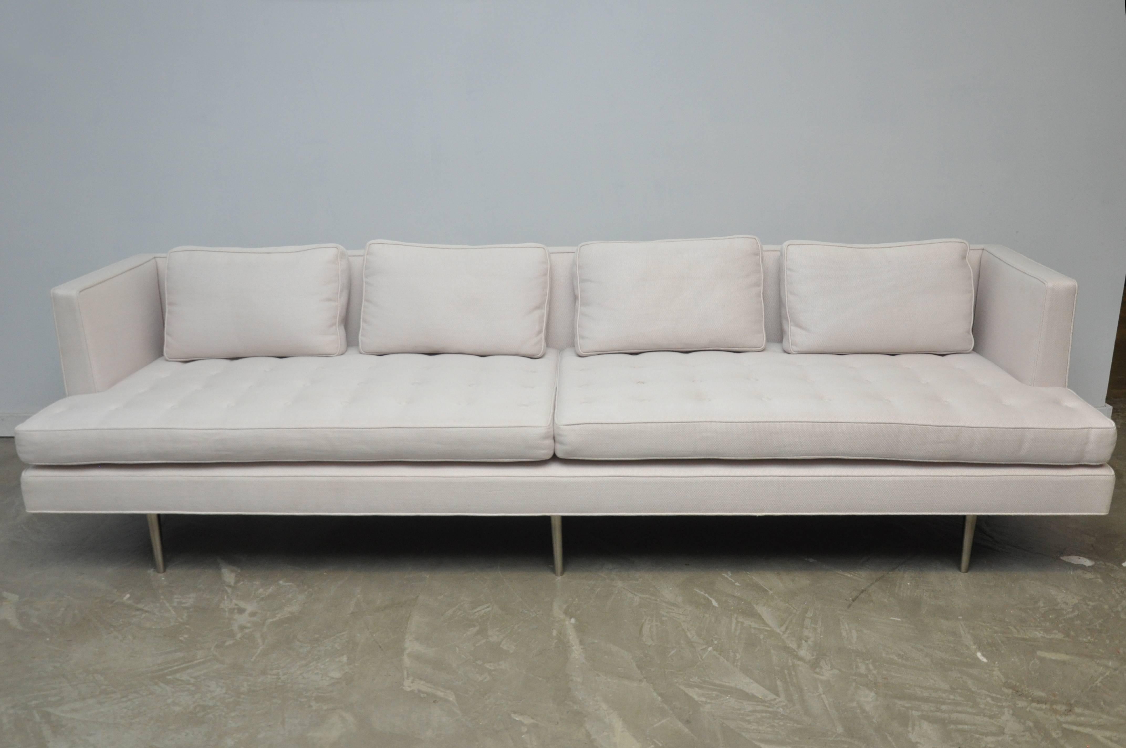 Classic Dunbar sofa designed by Edward Wormley, circa 1950. Fully restored, newer upholstery in woven white fabric over original polished nickel legs.