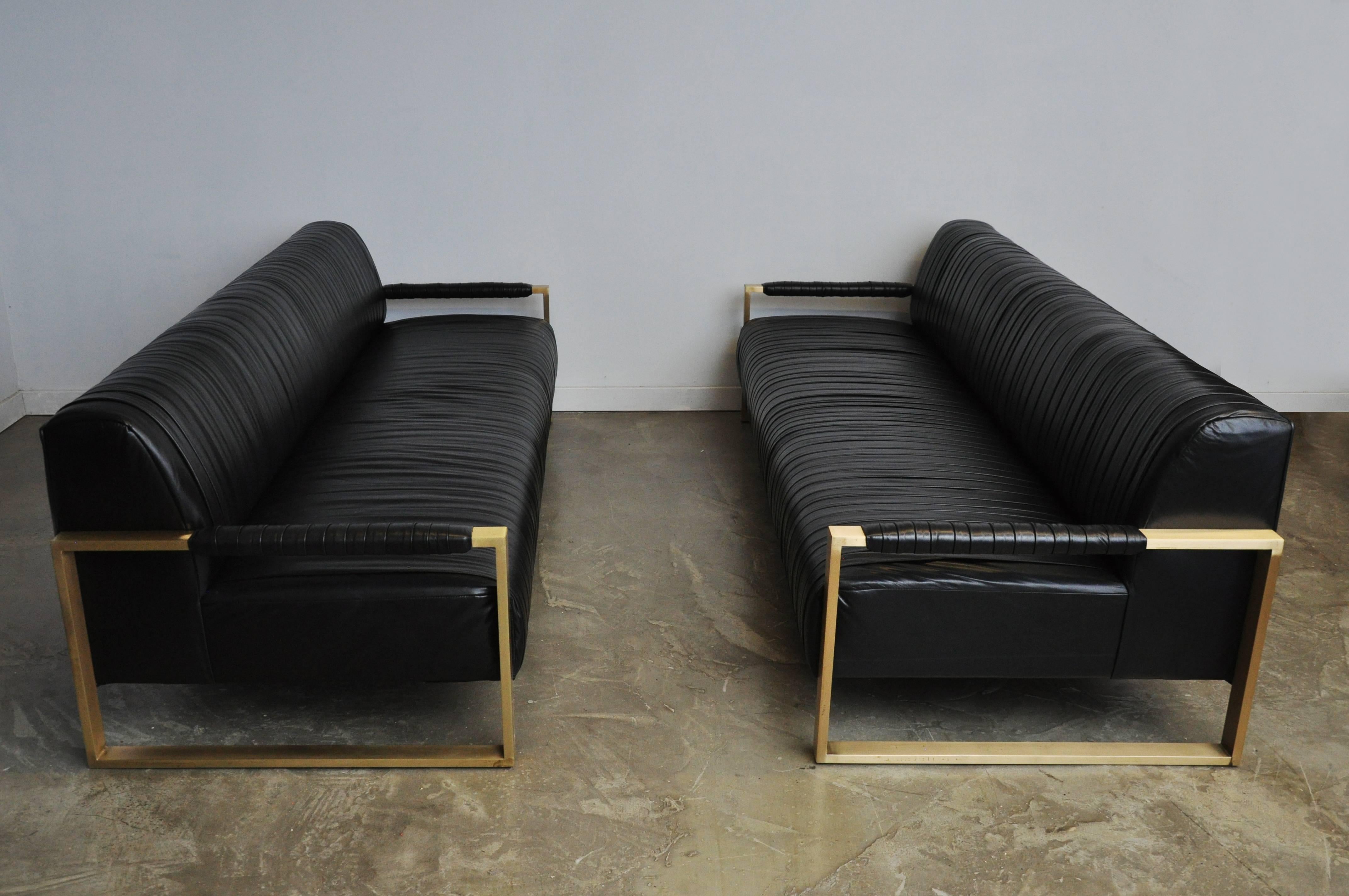 Beautiful pleated black leather sofa with brushed brass frames by Modern Drama. 

Pair available. Priced individually.

Bespoke sofas available in custom options: choice of frame finish, choice of leather/fabric/COM.
 