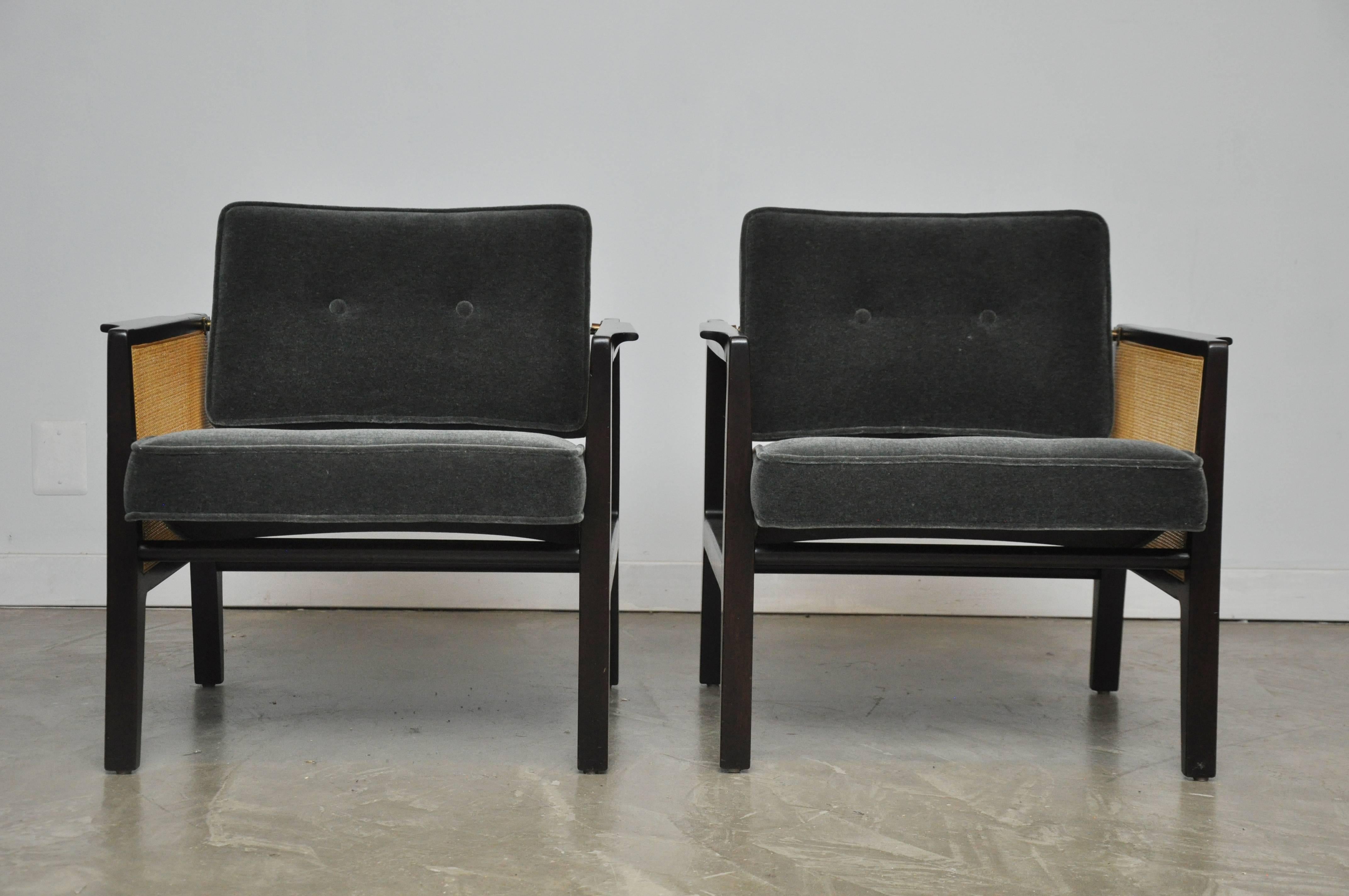 Beautiful cane sided lounge chairs by Edward Wormley for Dunbar. Model 5513, circa 1950s. Fully restored espresso finish frames with new cane and charcoal mohair upholstery. Back cushions have brass pivots to adjust for comfort.