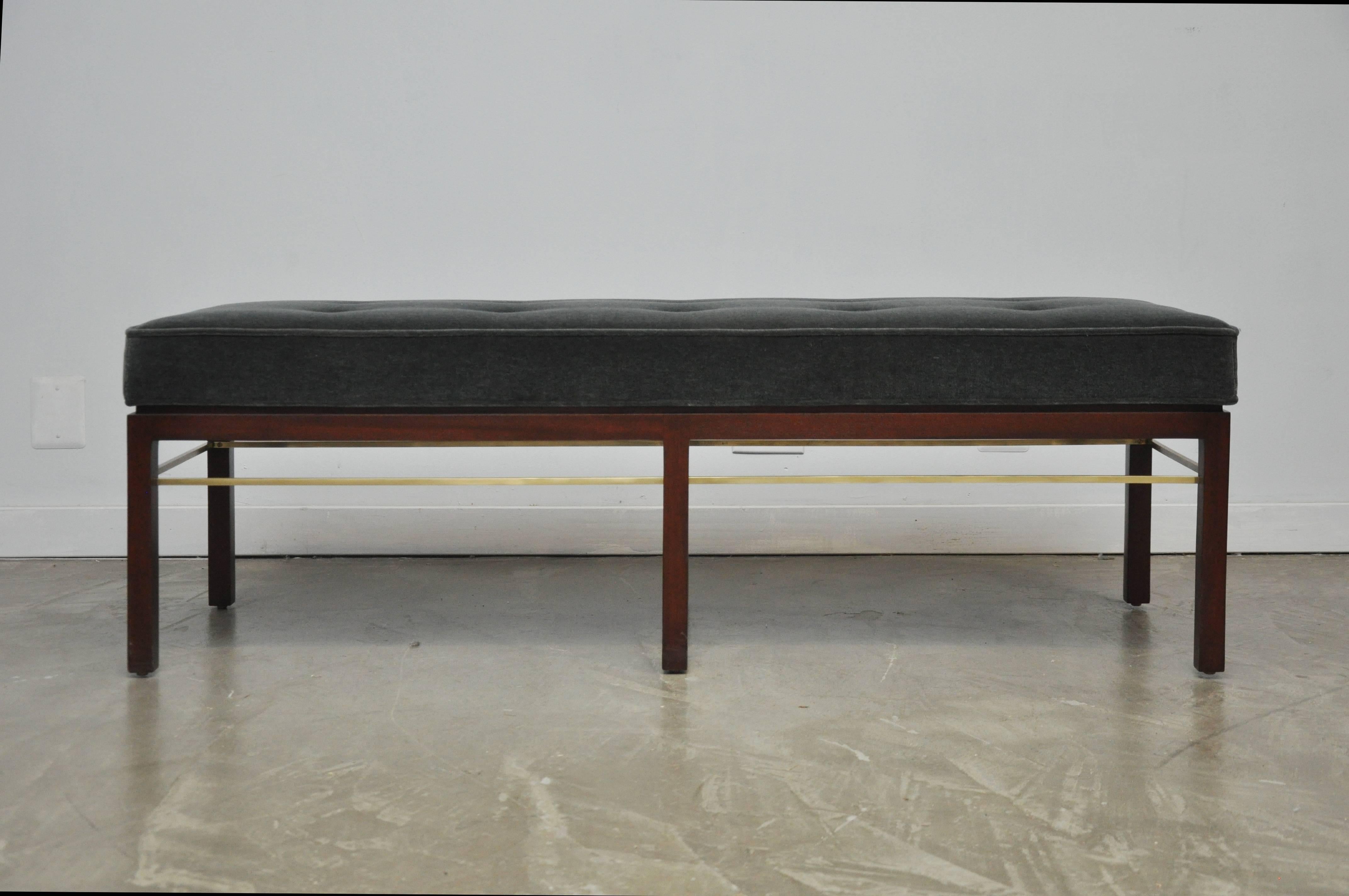 Beautiful bench by Edward Wormley for Dunbar. Fully restored mahogany frame in walnut finish. Polished brass stretcher around the interior of entire frame. New dark grey mohair upholstery.