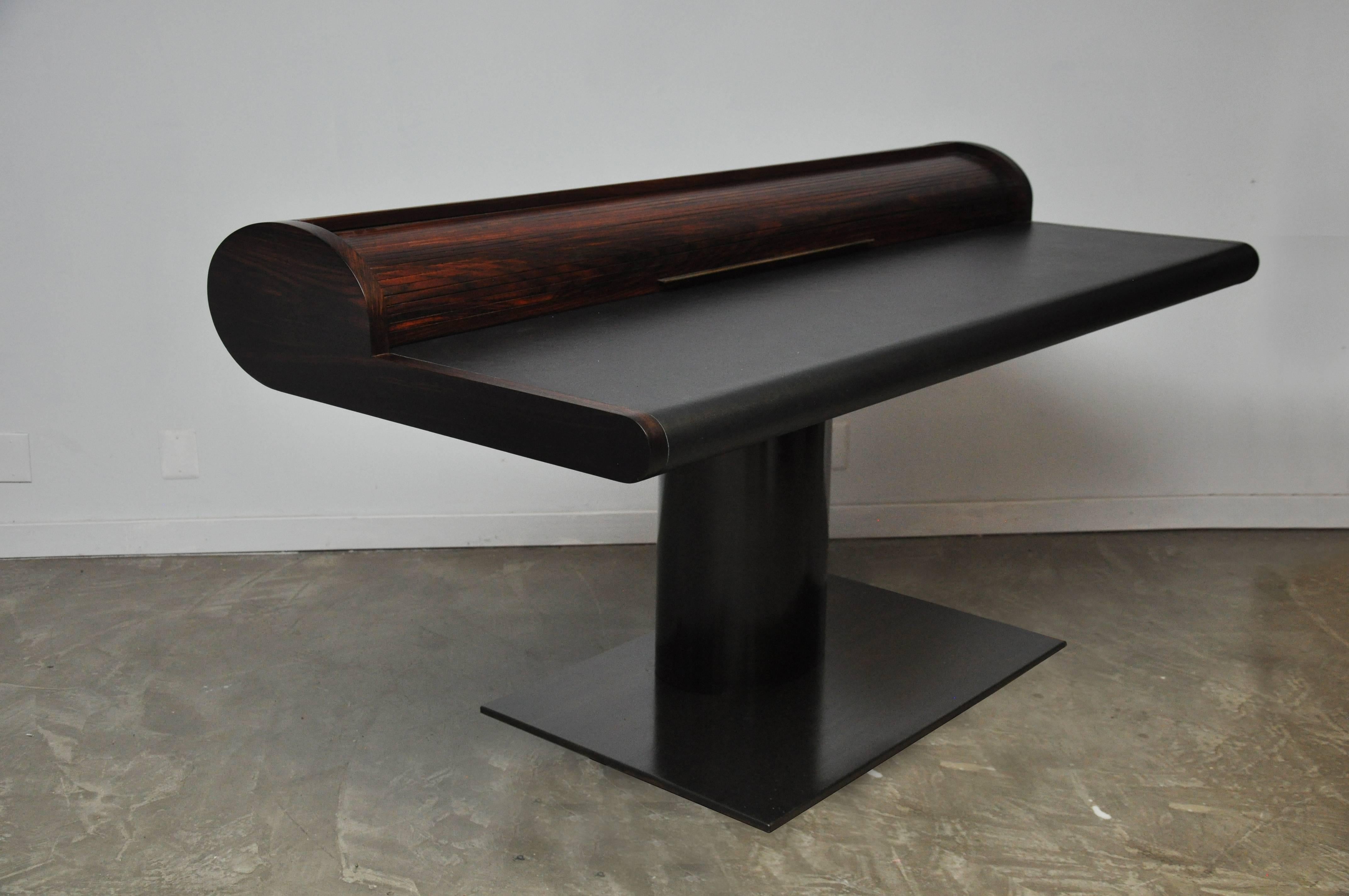 Desk by Edward Wormley for Dunbar. This custom ordered desk features a rosewood top, black leather wrapped surfaces, and floating on bronze pedestal base. Bronze details on desk throughout. The electronic panel behind the roll top has brand new