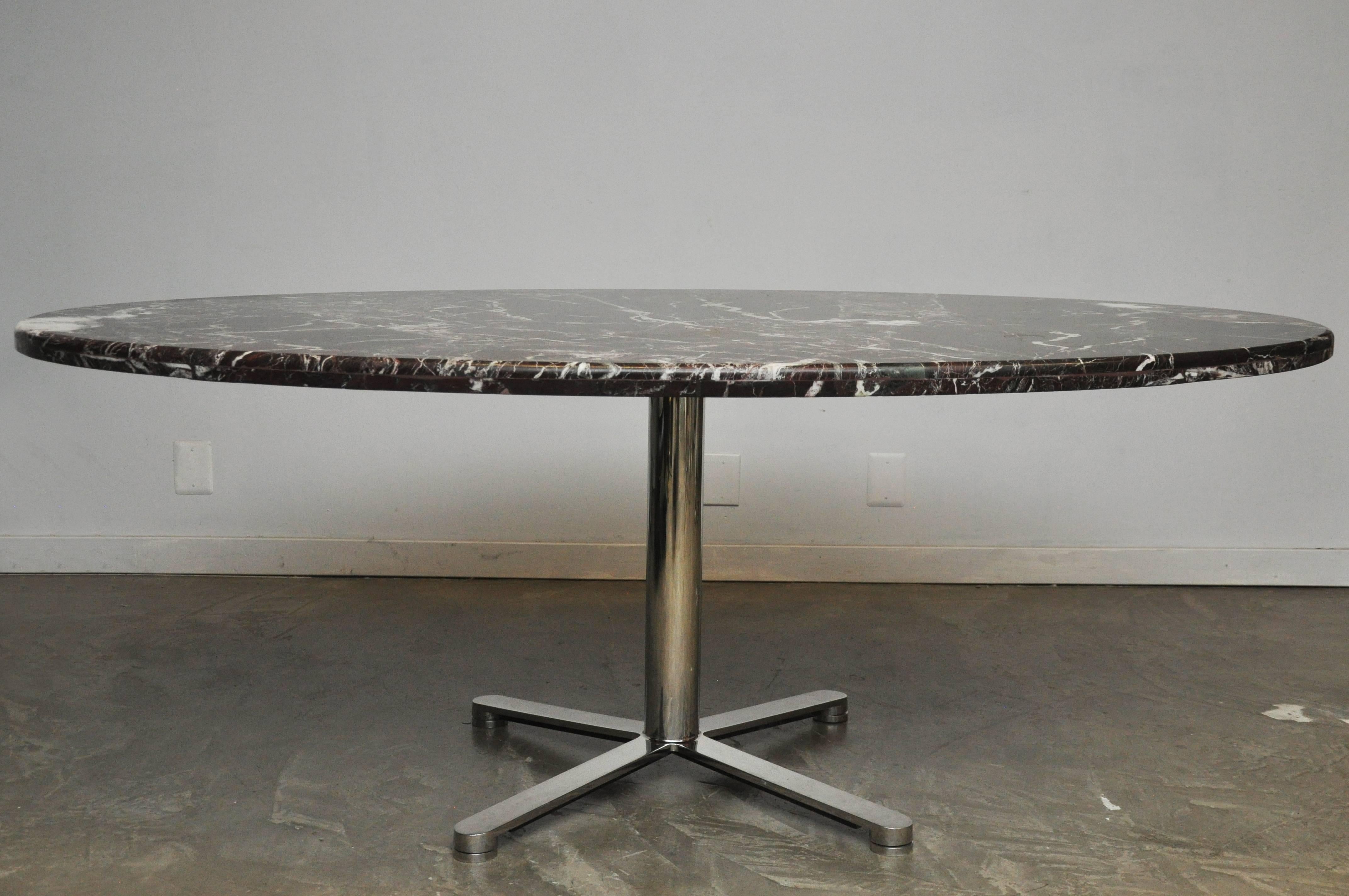 Oval dining table by Nicos Zographos, circa 1980. Polished stainless steel base with a beautiful rosso levanto, Italian marble top.