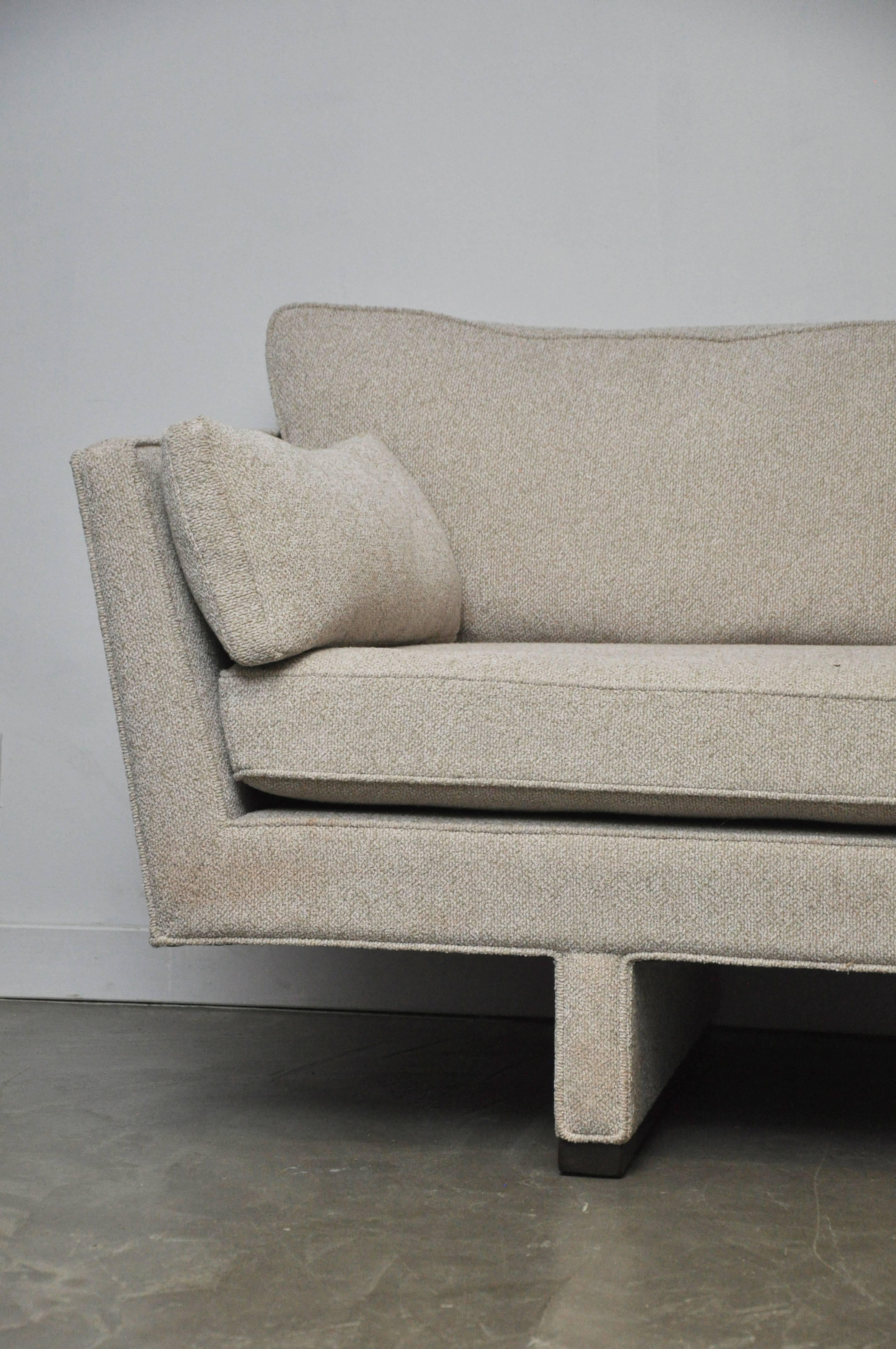 Rare form Dunbar sofa by Edward Wormley. Fully restored. New upholstery in cream white boucle with refinished walnut stained mahogany ski bases. Retains original Dunbar decking.