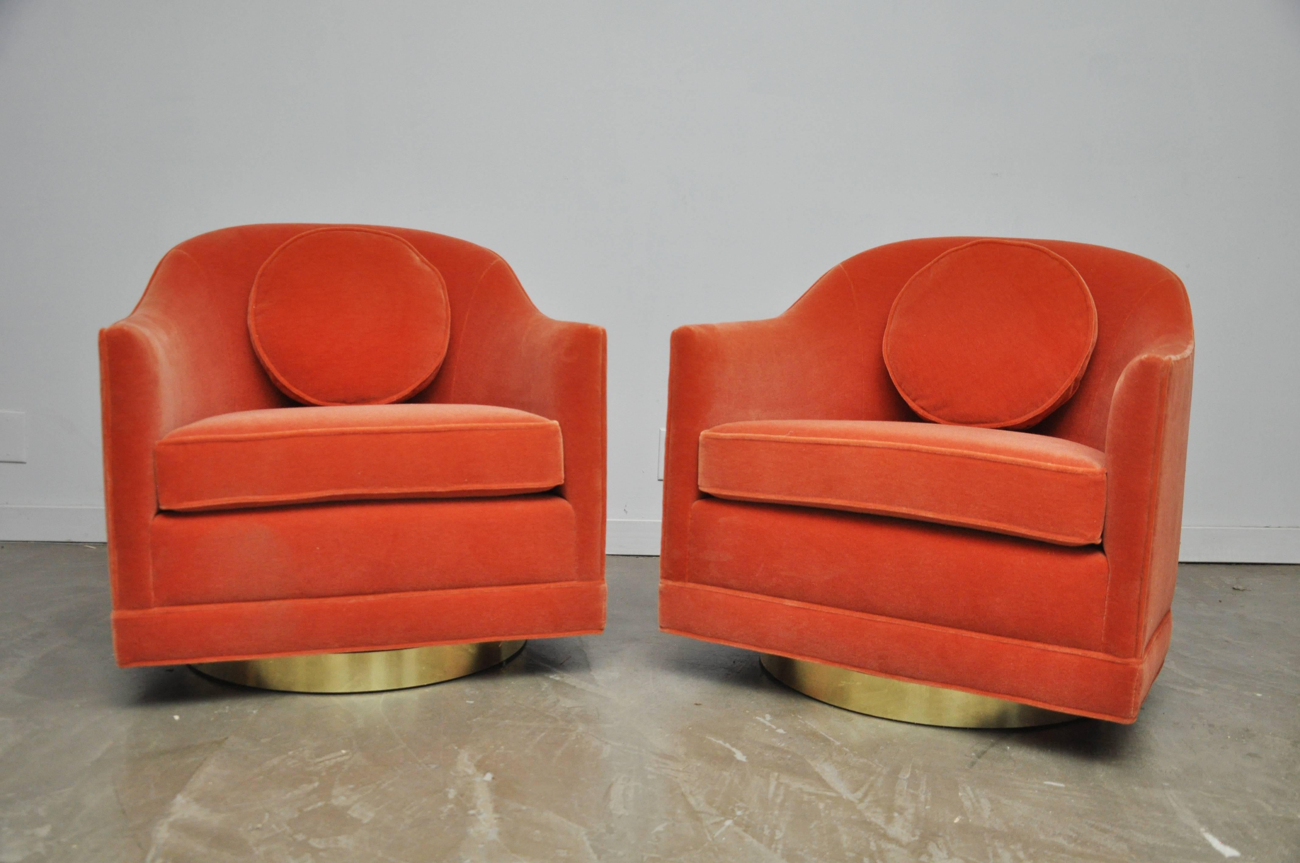 Beautiful pair of swivel chairs by Harvey Probber. Fully restored and reupholstered in coral mohair over brass swivel bases.