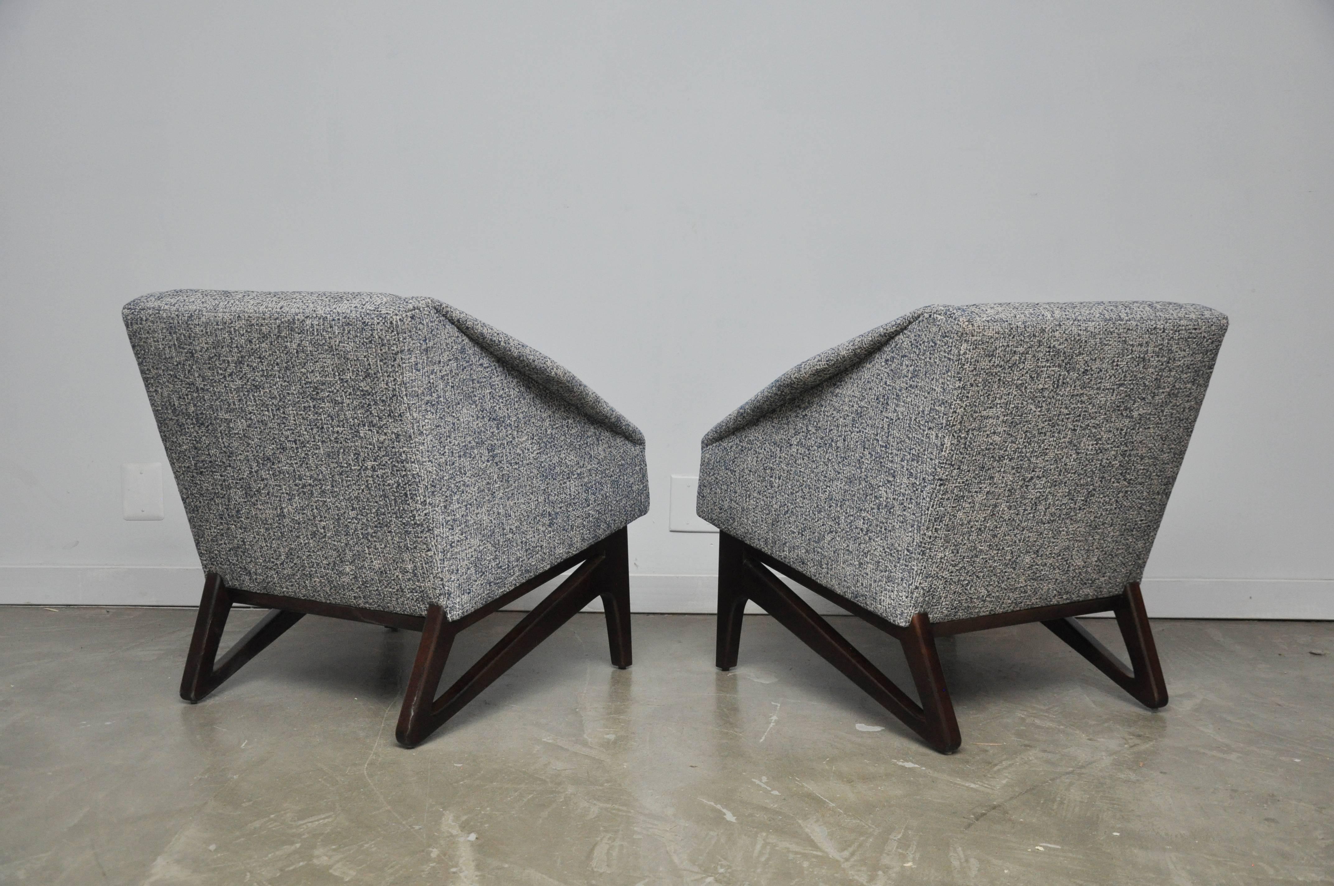 Italian lounge chairs with sculptural from walnut bases with diamond form arms. Fully restored and reupholstered in new blue or white weave fabric.