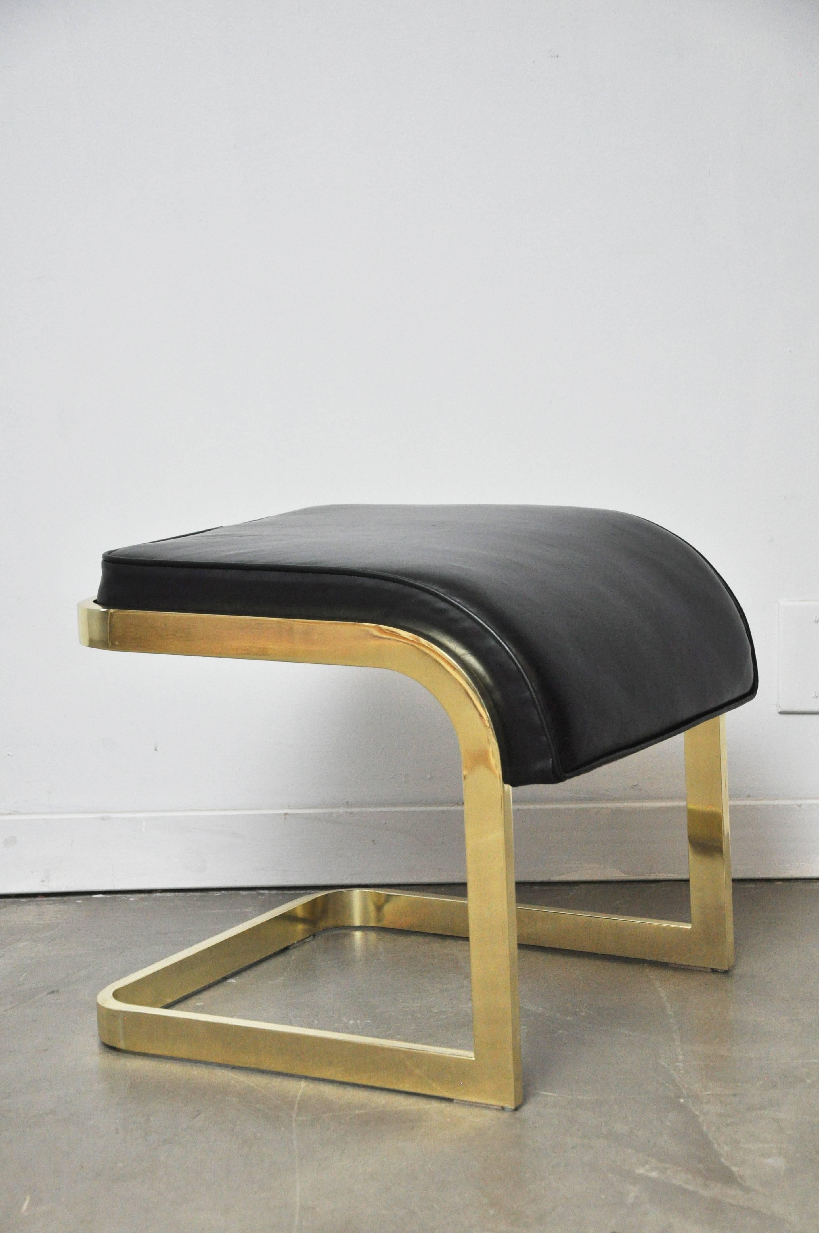 Pair of brass frame stools with new black leather cushions. Design Institute, circa 1970s.