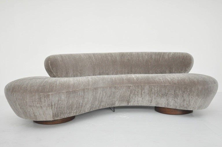 Serpentine sofa by Vladimir Kagan. Newly upholstered in ultra plush mohair over walnut bases.