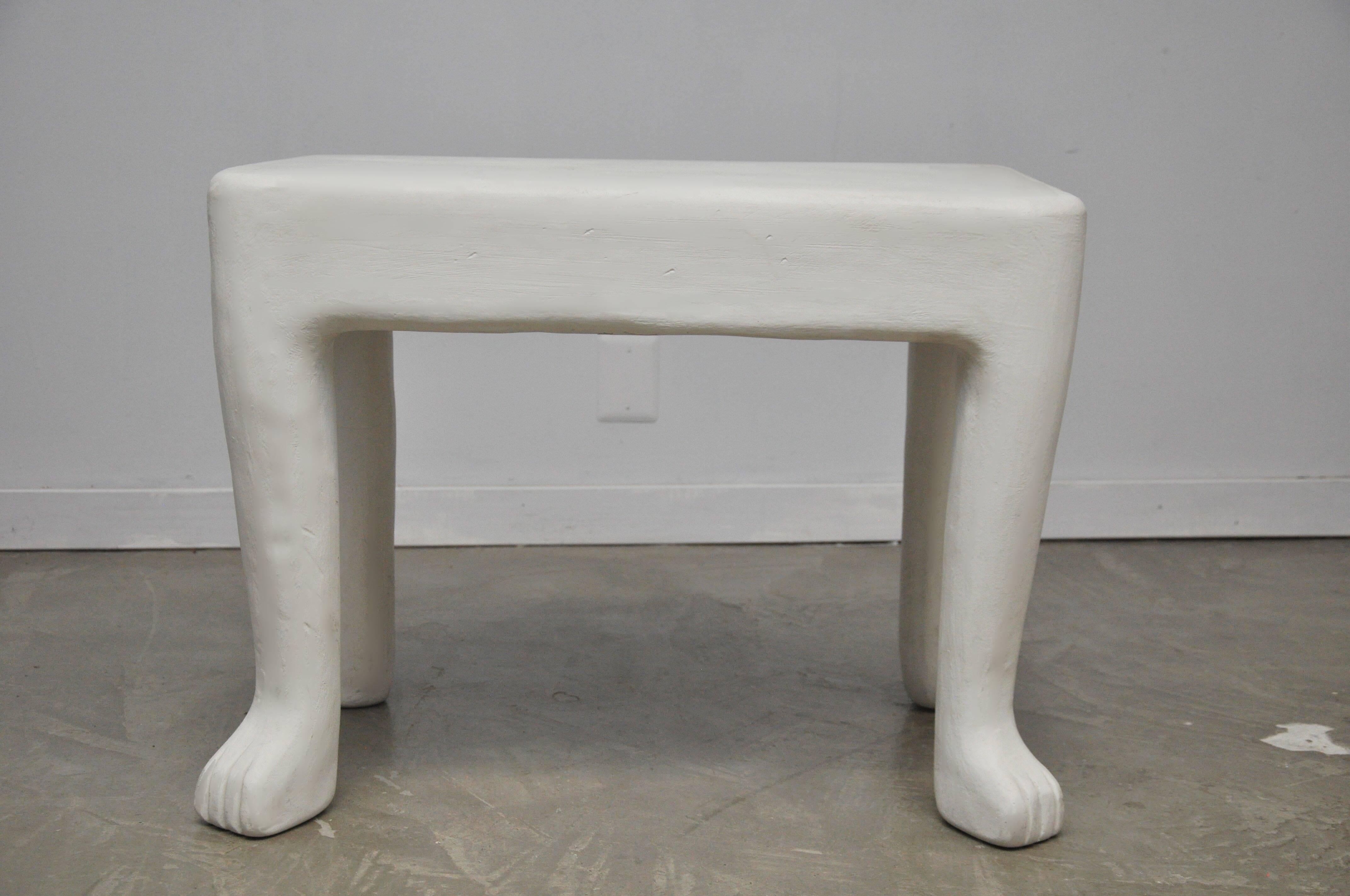 We are proud to offer this authentic white plaster John Dickinson occasional side table. Cast plaster with four primitive animal paw legs. circa 1970s.