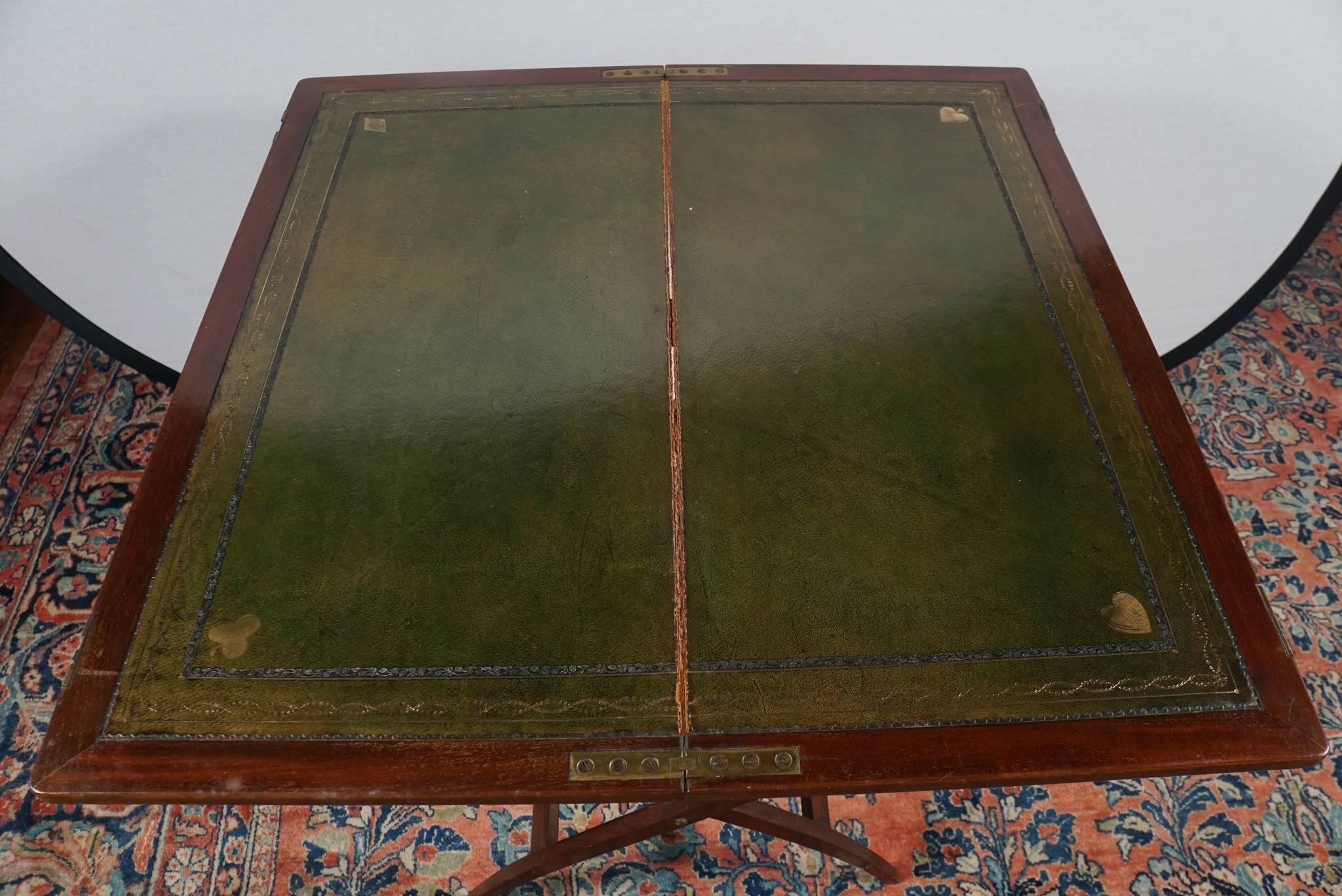 Nice 19th century English mahogany coaching or card table having an embossed and gilded green leather top.