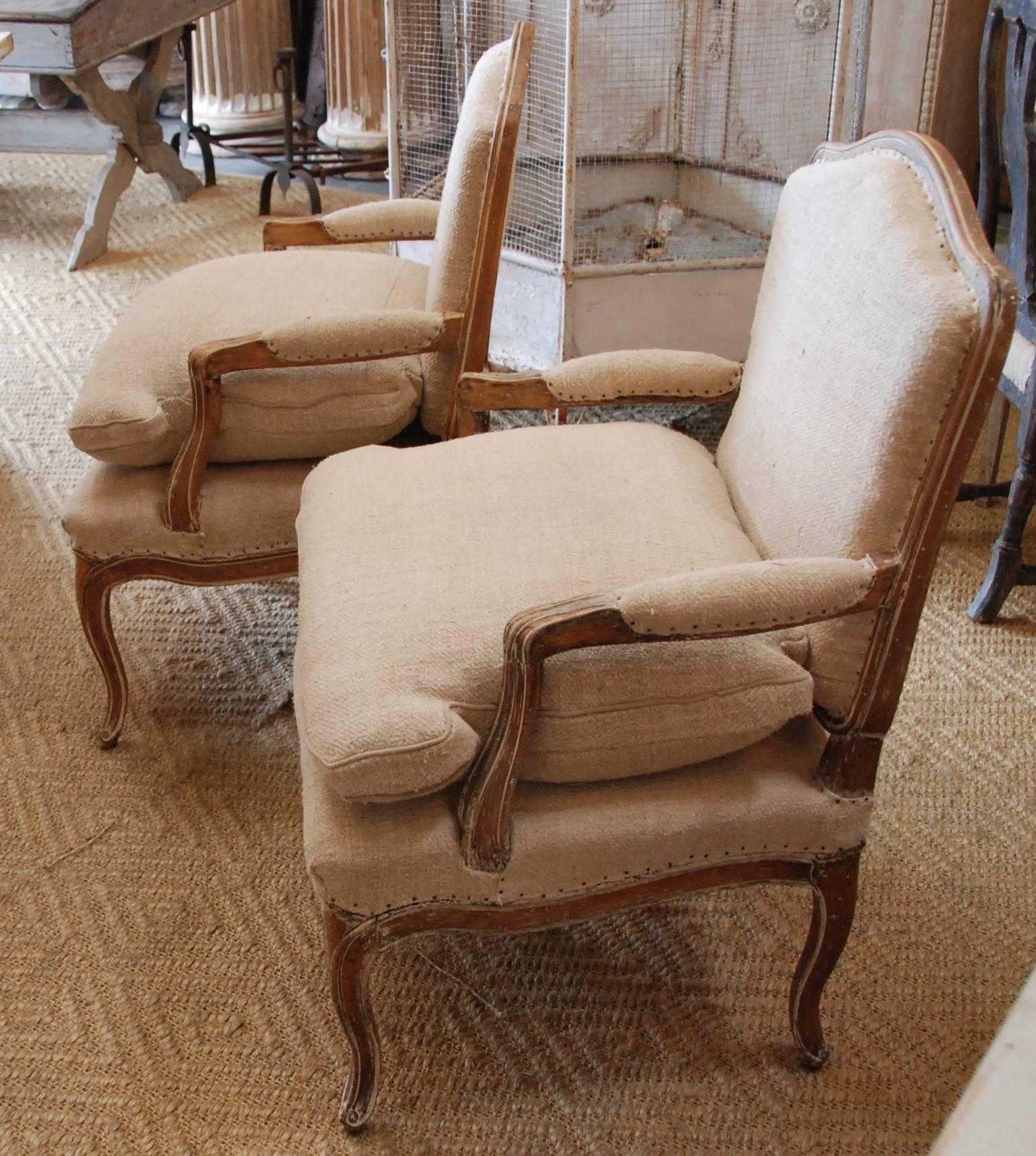 A pair of 19th century French bergère chairs stripped down to lovely aged pine patina. Upholstered in French antique hemp. Sturdy and comfortable.
 