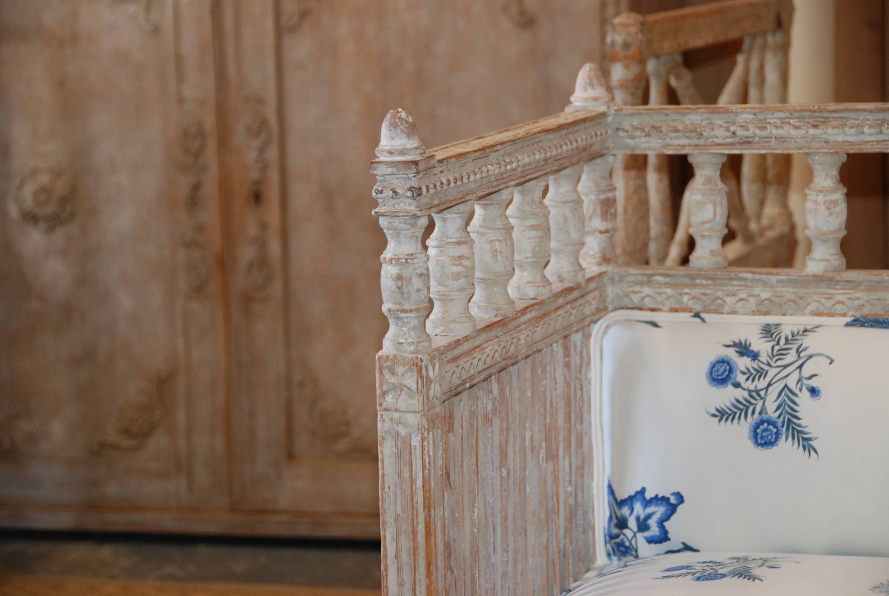 Beautiful 18th century Swedish period sofa scraped down to the original white color. Lovely carved sides, back and apron. Newly upholstered in crisp blue and white Brunschwig & Fils fabric.