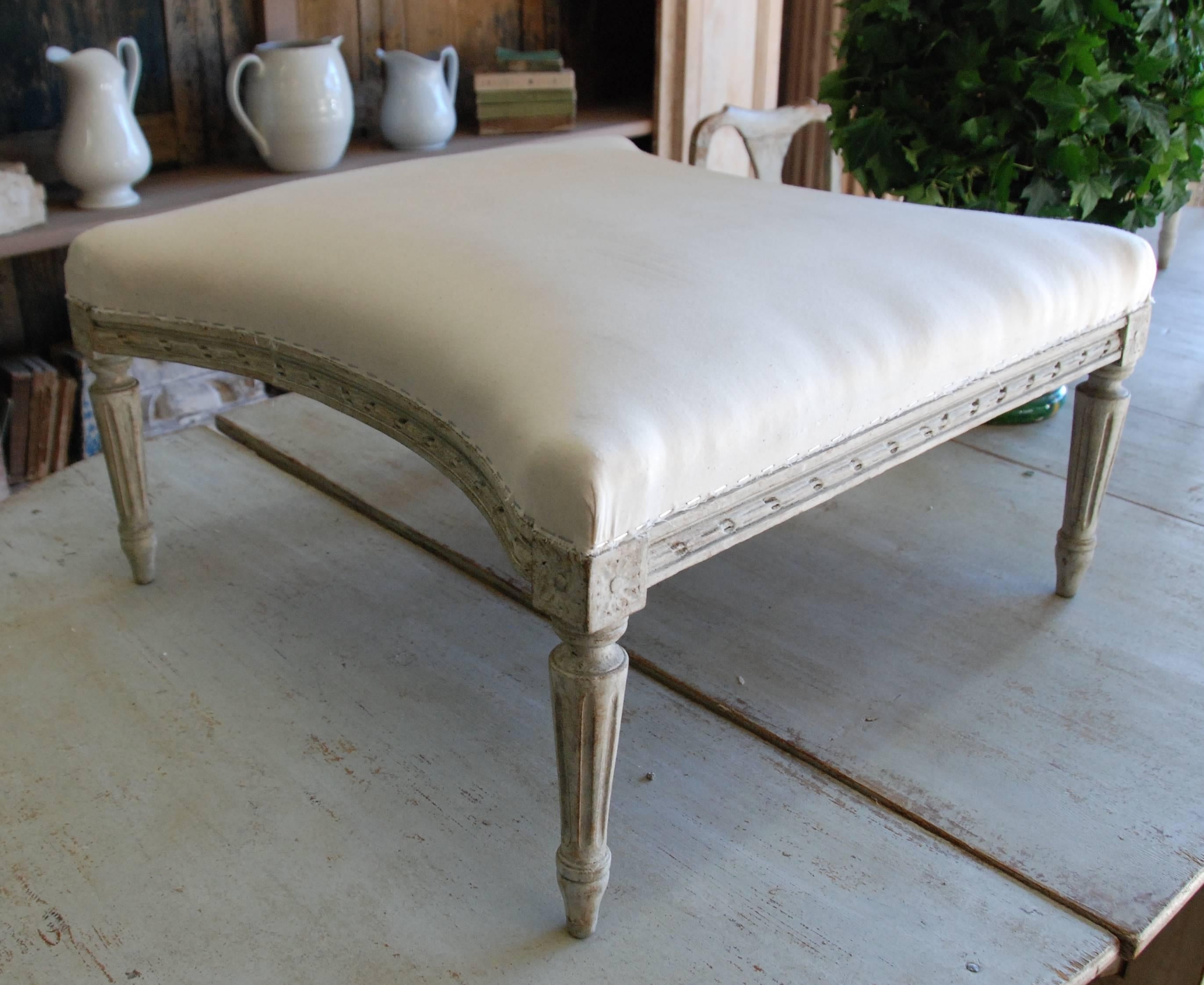 19th century Swedish tapered footstool scraped down to original cream color. Lovely hand-carved apron and fluted legs.
