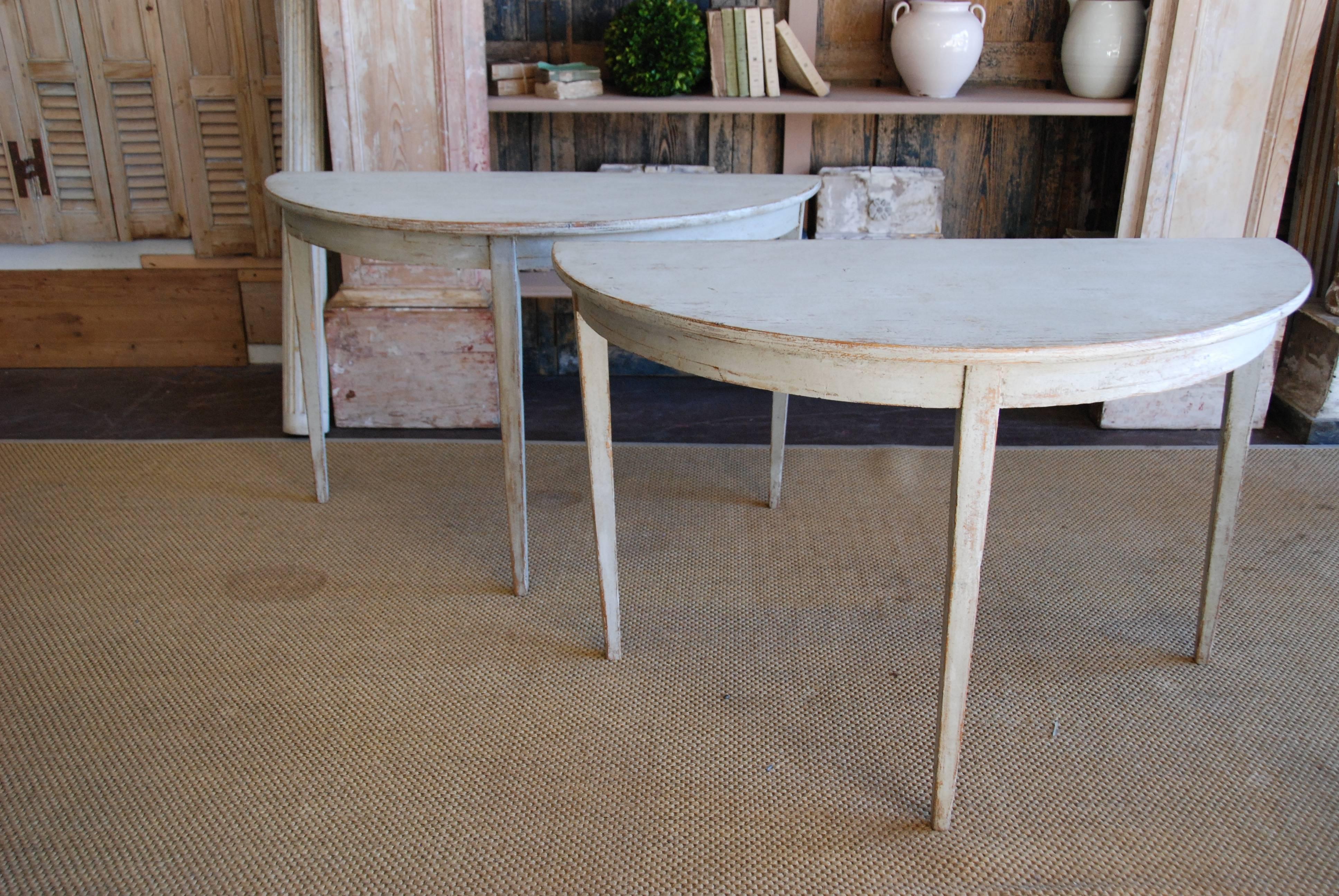 Pair of 19th century Swedish demilune tables with rounded base and tapered legs. Can be put together to form a round table. Cream, white color.