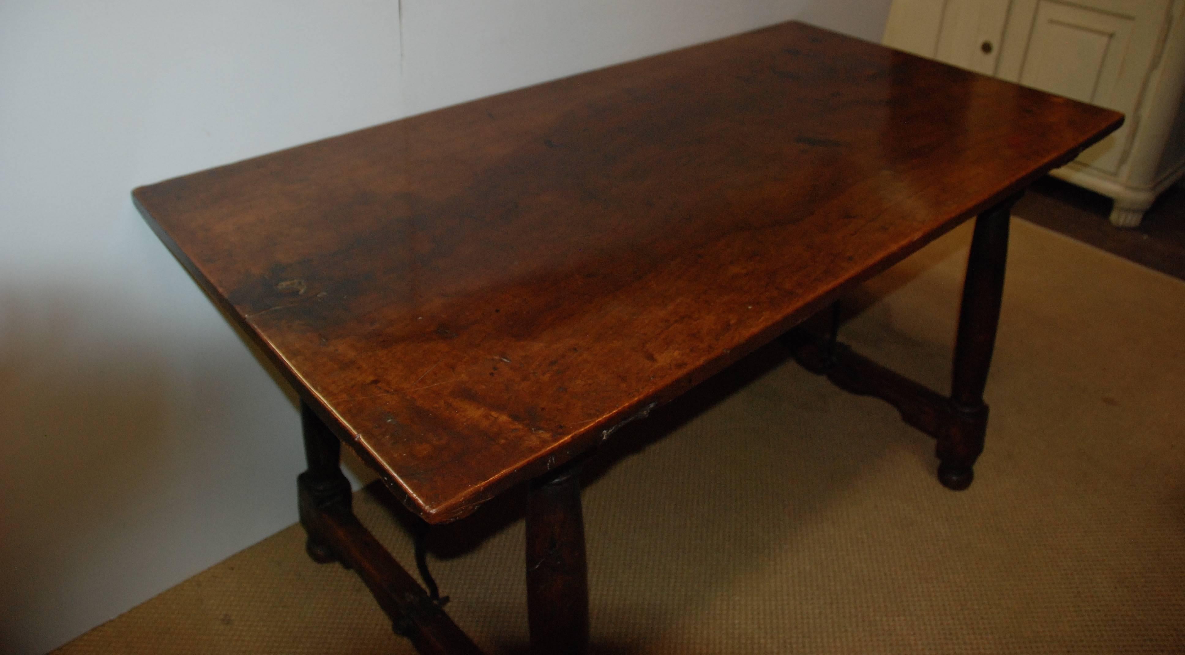17th Century Portuguese walnut table iron base. Beautiful aged walnut top that is one piece of solid wood. All original.
