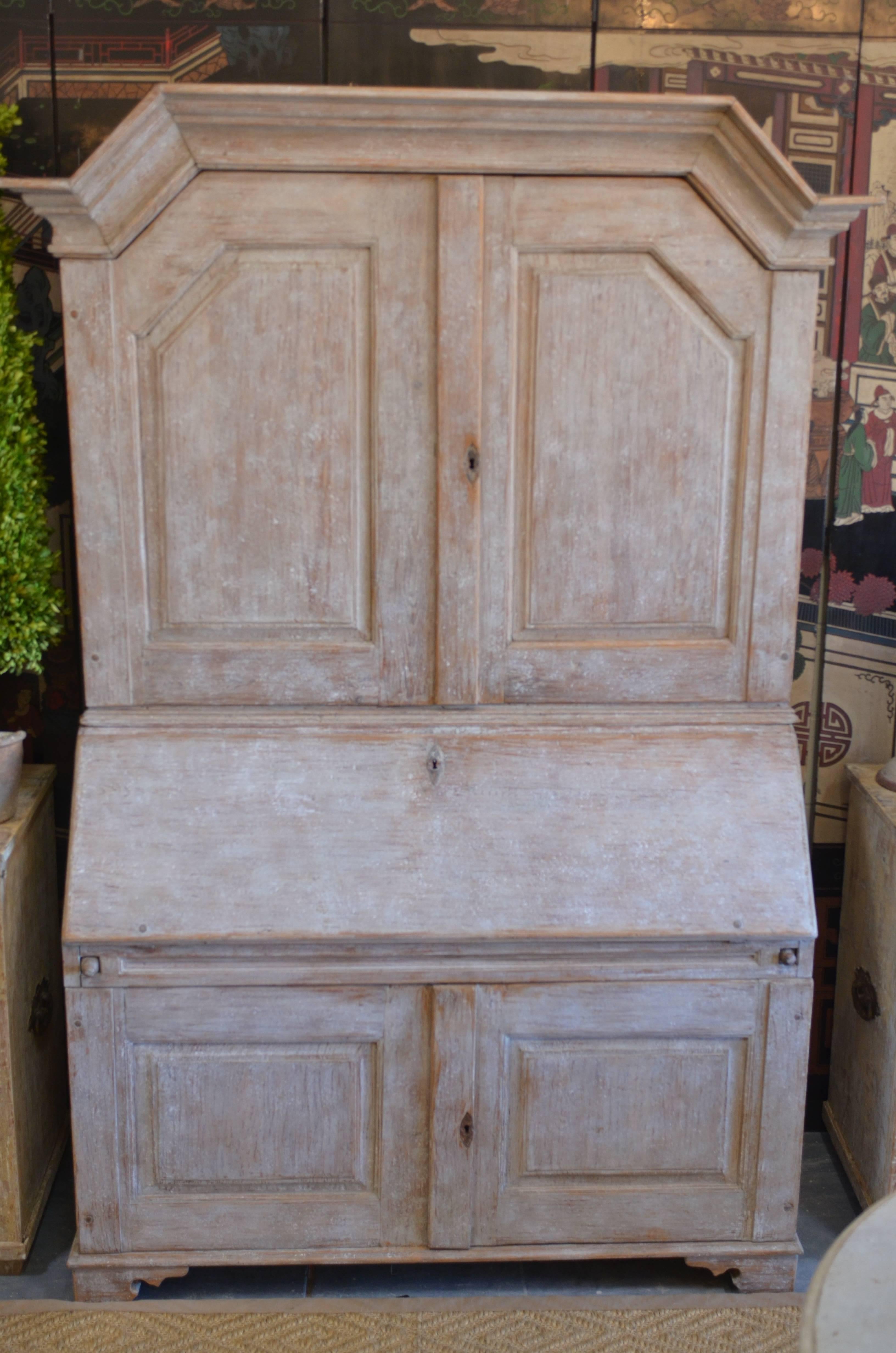 Beautiful Swedish baroque Secretary. Lovely original cream/ white color with Swedish blue slant front desk interior. Upper and lower desk have two carved raised paneled doors that both open to plenty of shelves for storage. Original initials left