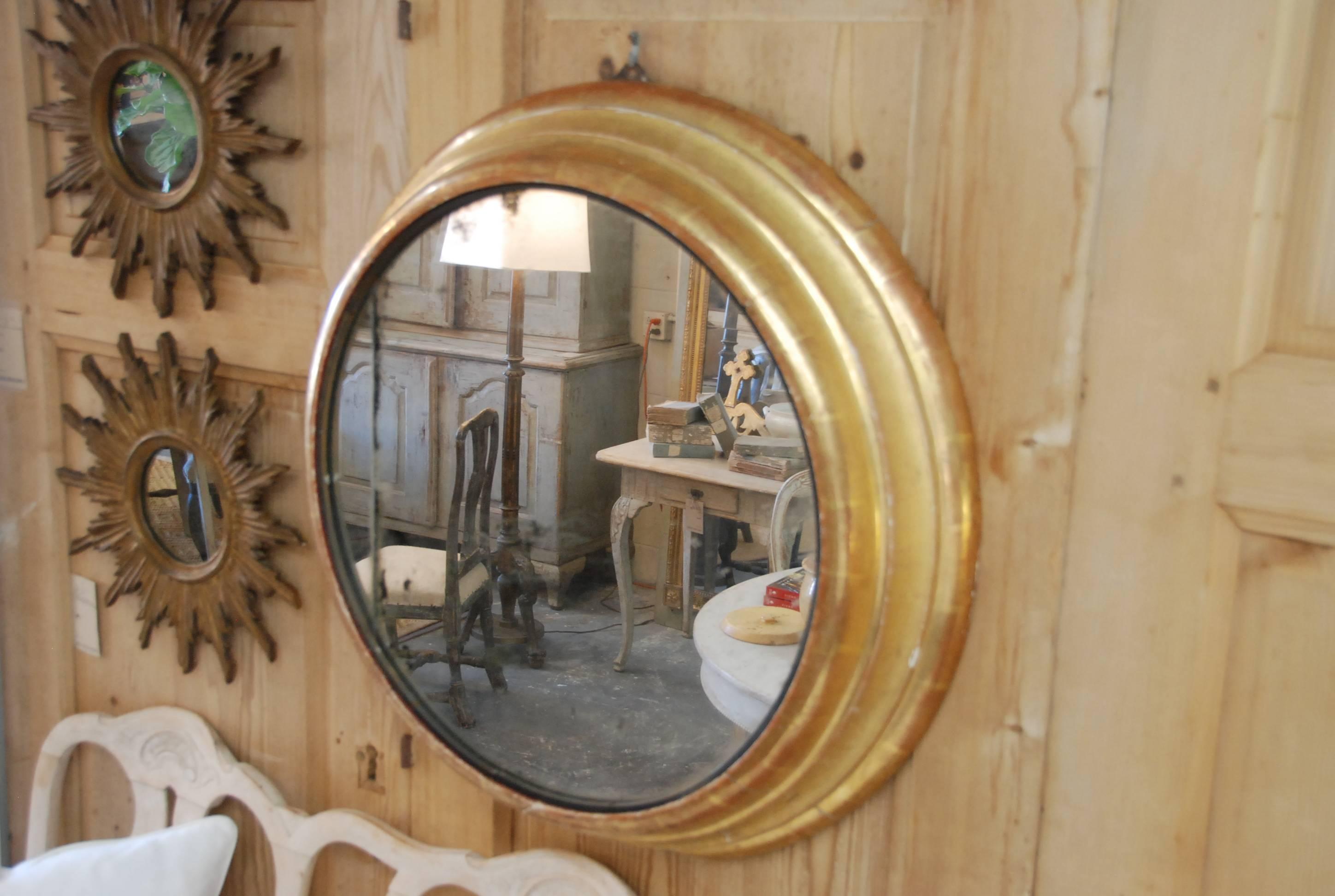 Very Unique 19th Century  French Round  Gilded Mirror with Mercury Glass. Notice in the photos, the bottom of the mirror has a flat edge.