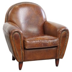 Vintage sheepskin club chair with black piping