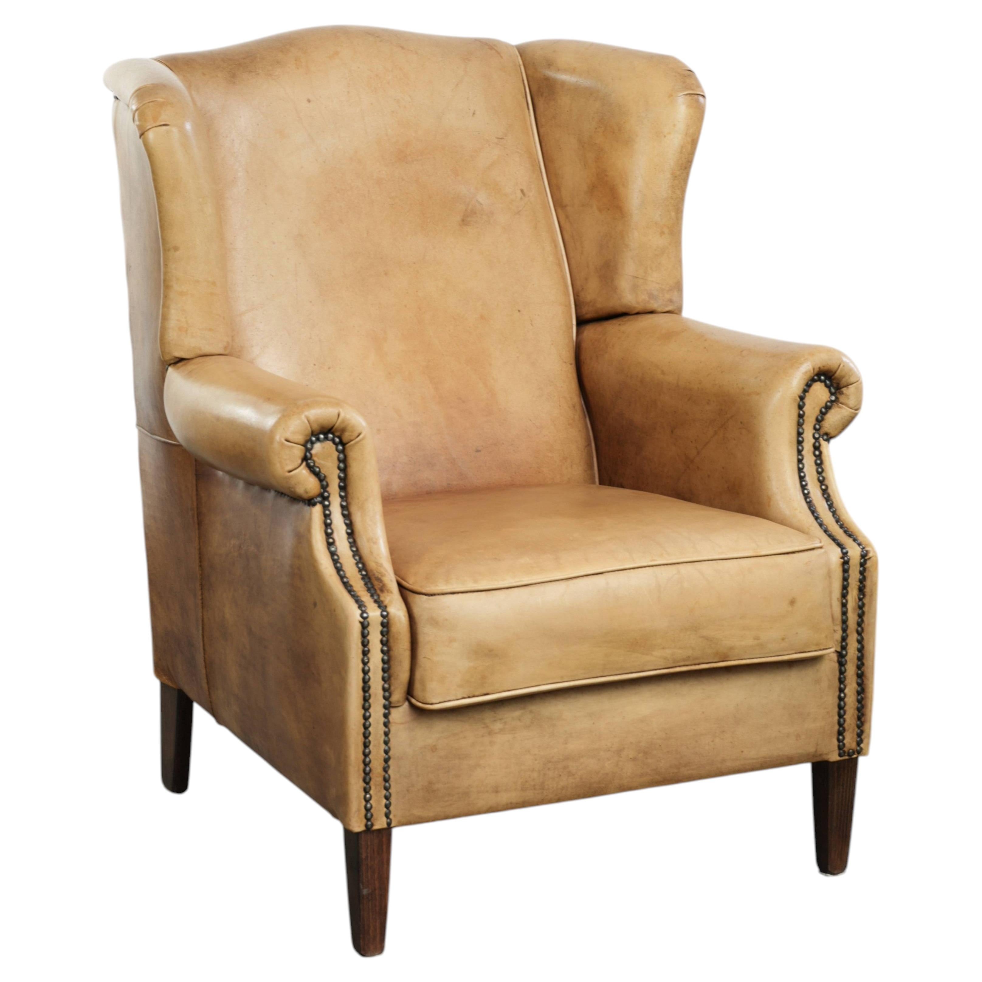 Fauteuil à oreilles en cuir de vache, au superbe style anglais intemporel