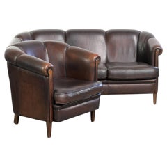 Set of a sheepskin sofa together with its matching club armchair