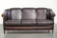 Set of a sheepskin sofa together with its matching club armchair