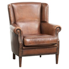 Subtle dark brown sheepskin wingback armchair with a timeless look subtle